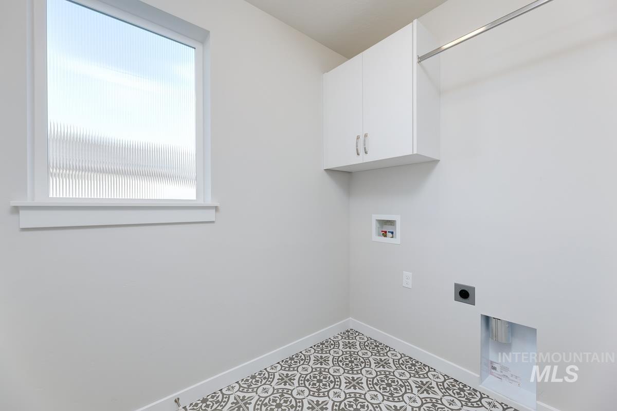 Laundry room featuring washer hookup, hookup for an electric dryer, and cabinet space