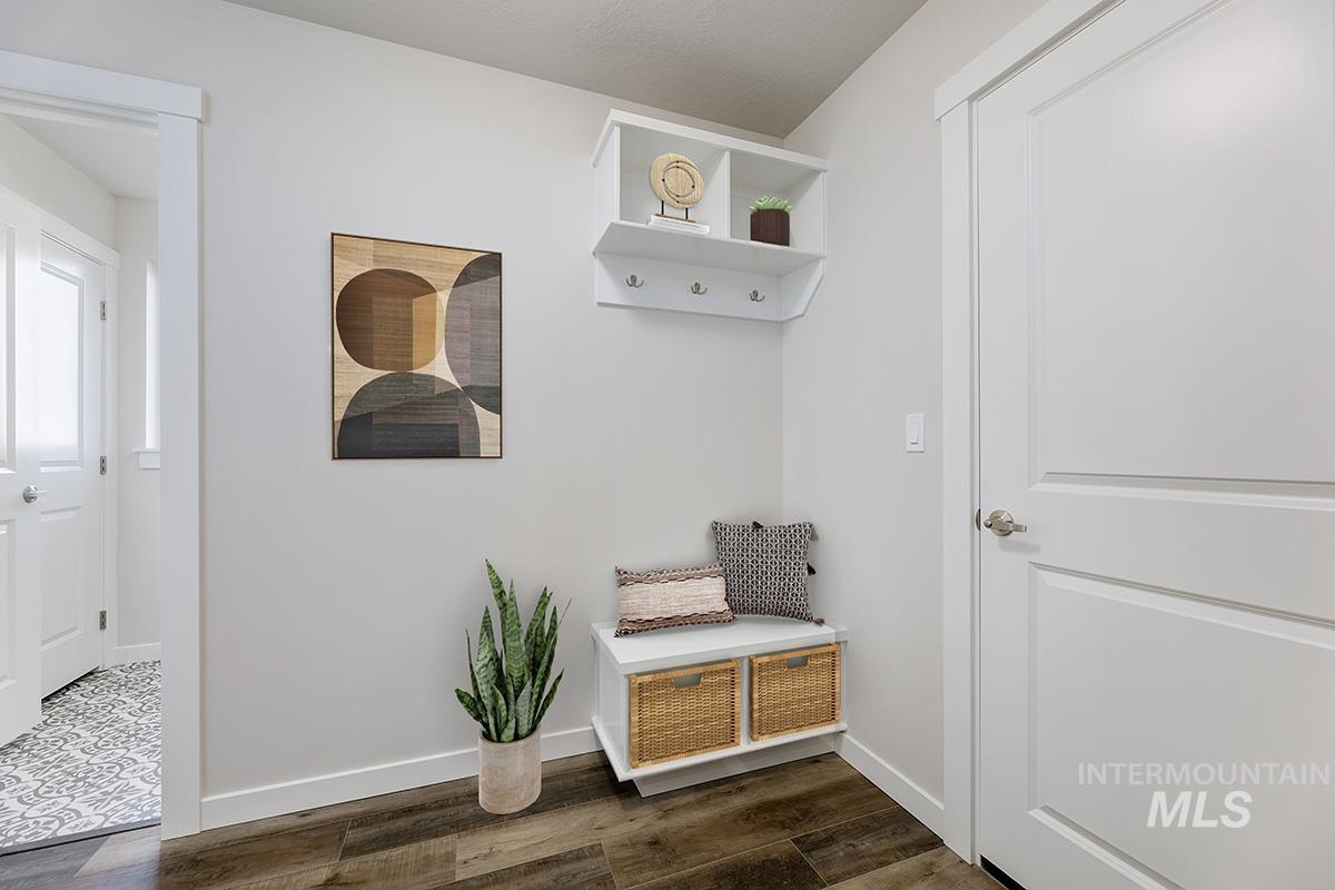 Mudroom with dark wood-style floors and baseboards