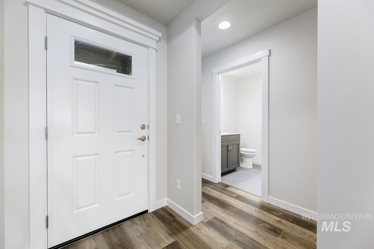 Foyer entrance with light wood-type flooring and recessed lighting