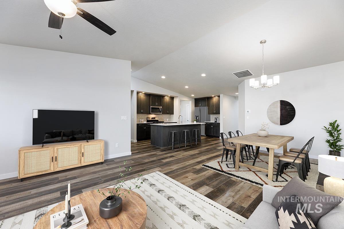 Living room with lofted ceiling, ceiling fan, dark wood-style floors, a chandelier, and recessed lighting