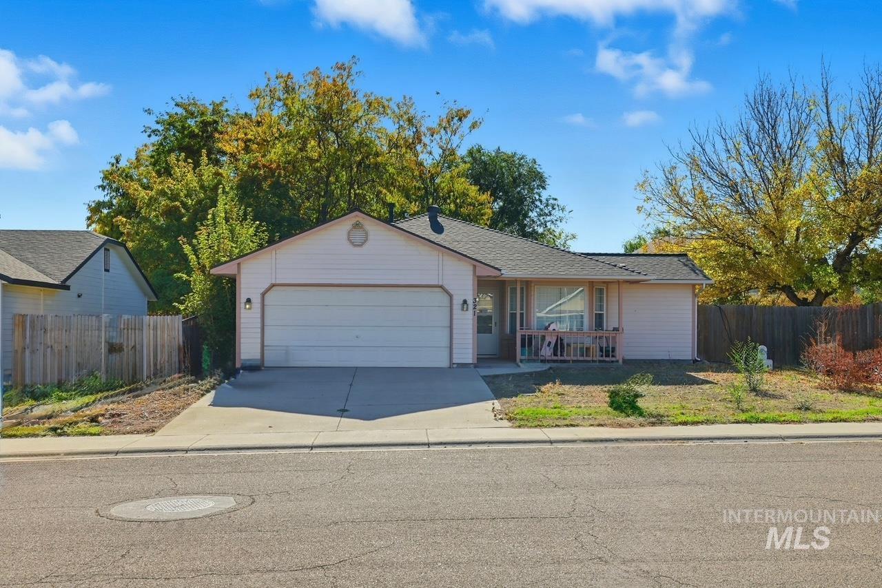 Ranch-style home featuring an attached garage and driveway