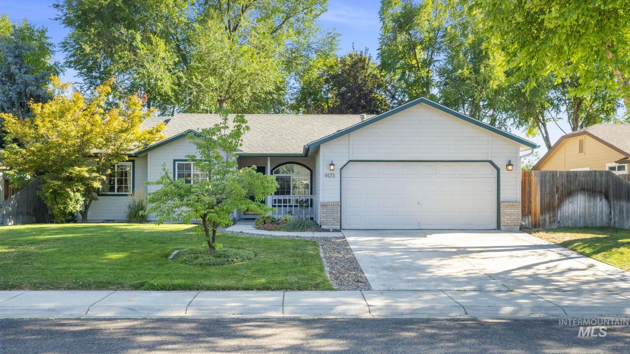 Ranch-style home featuring concrete driveway, a garage, and a shingled roof