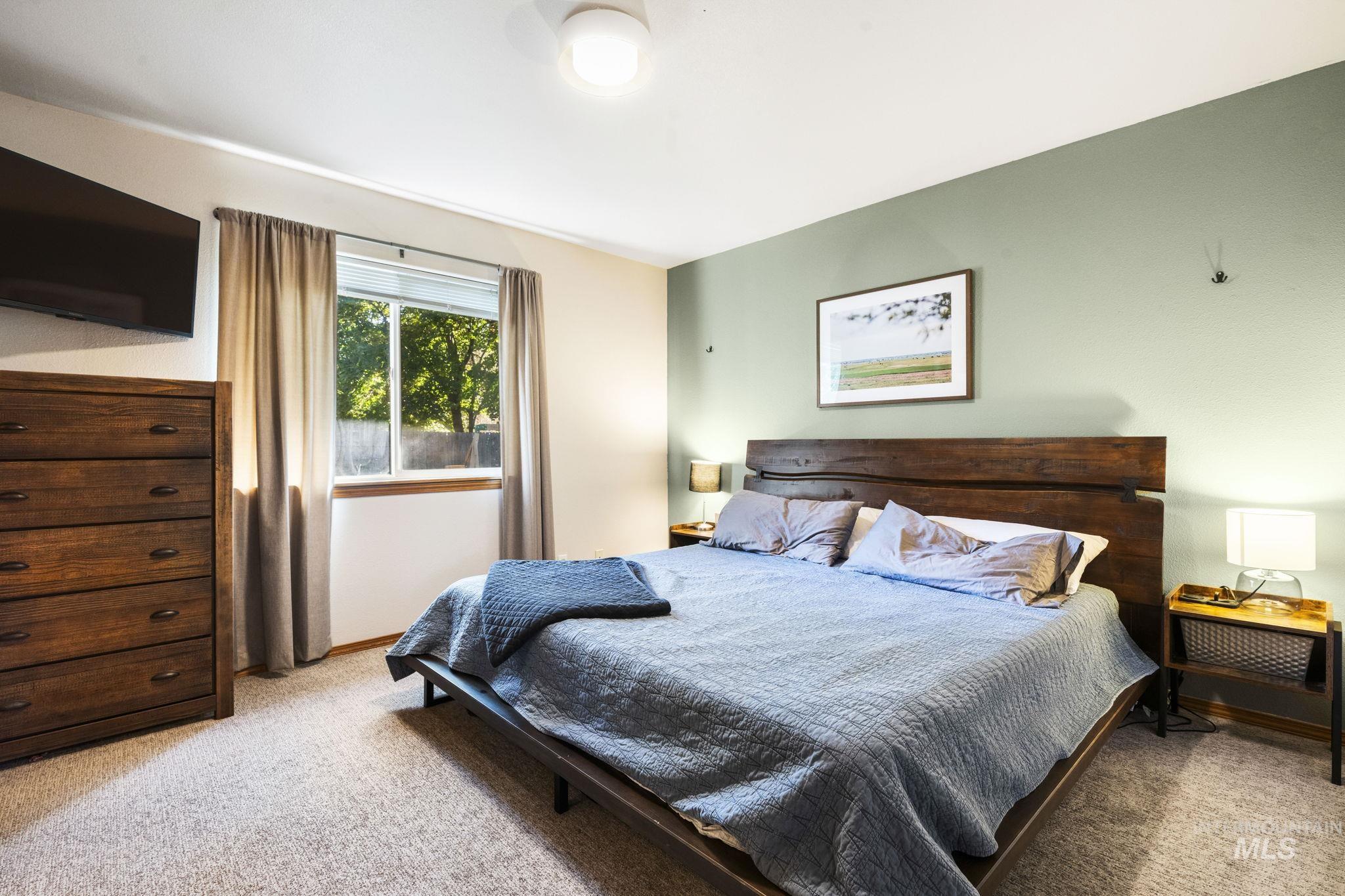 Bedroom featuring light colored carpet