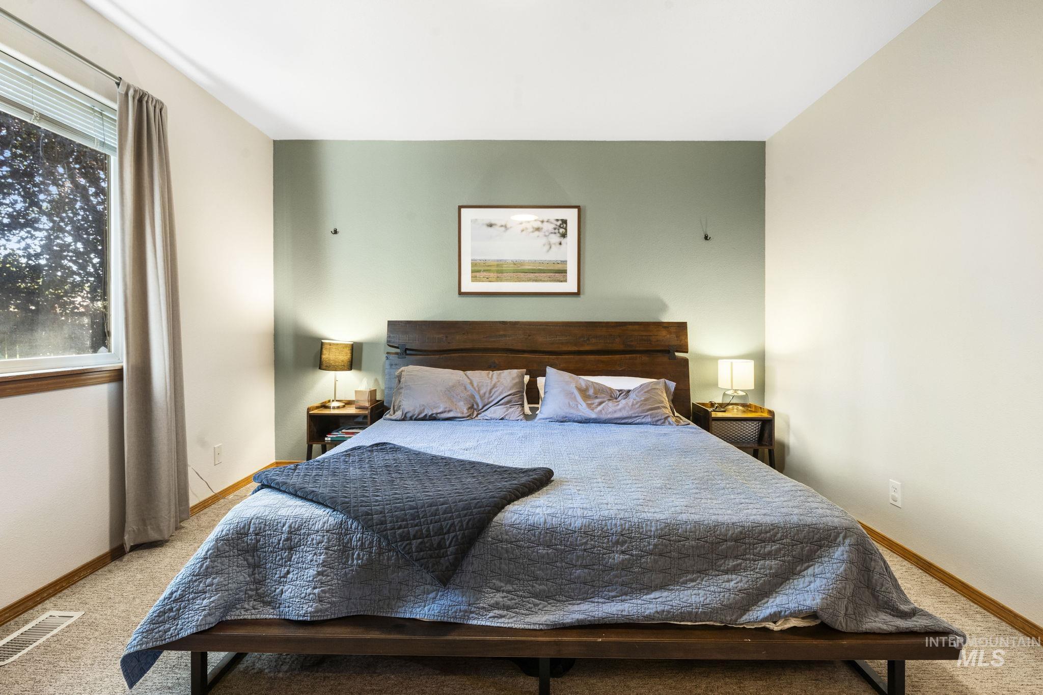 Bedroom featuring carpet flooring and baseboards