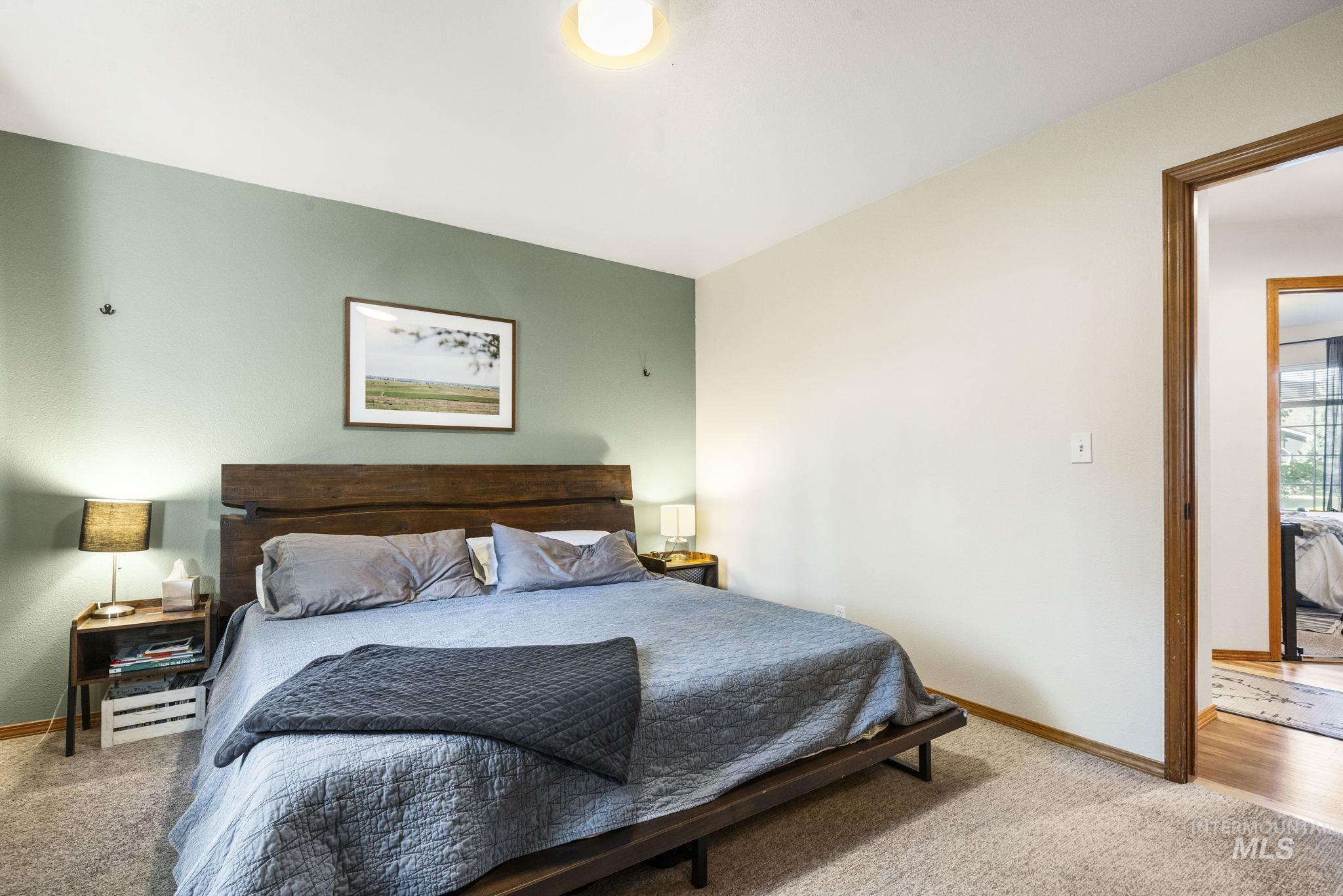 Carpeted bedroom featuring baseboards
