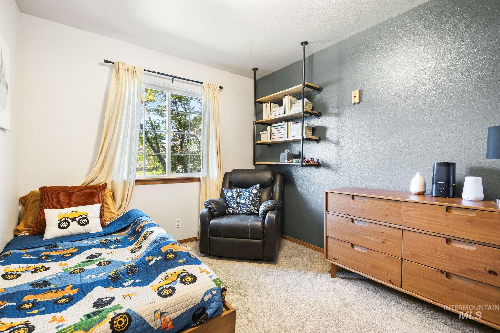 Bedroom featuring light carpet and baseboards