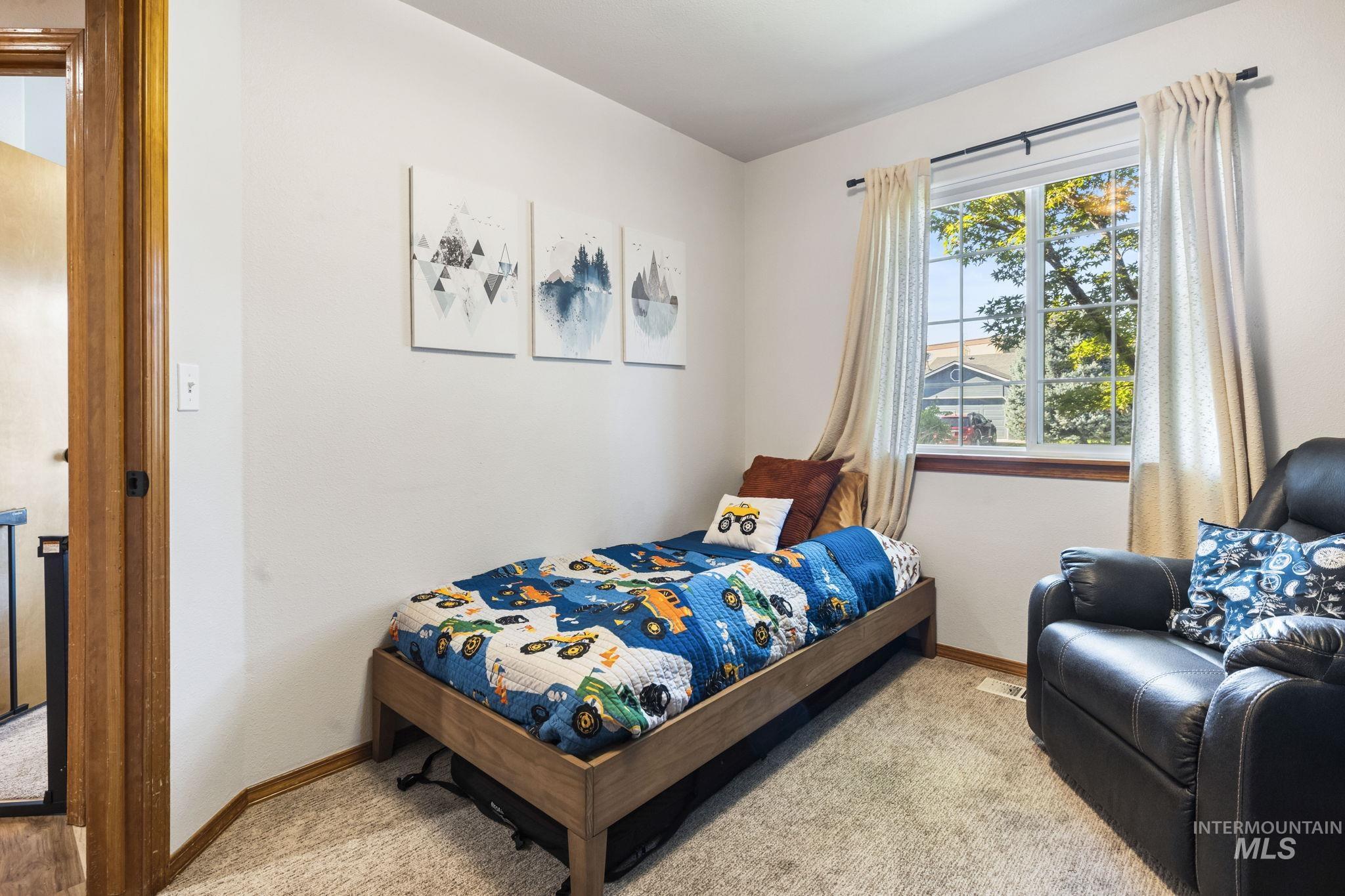 Bedroom featuring baseboards and light colored carpet