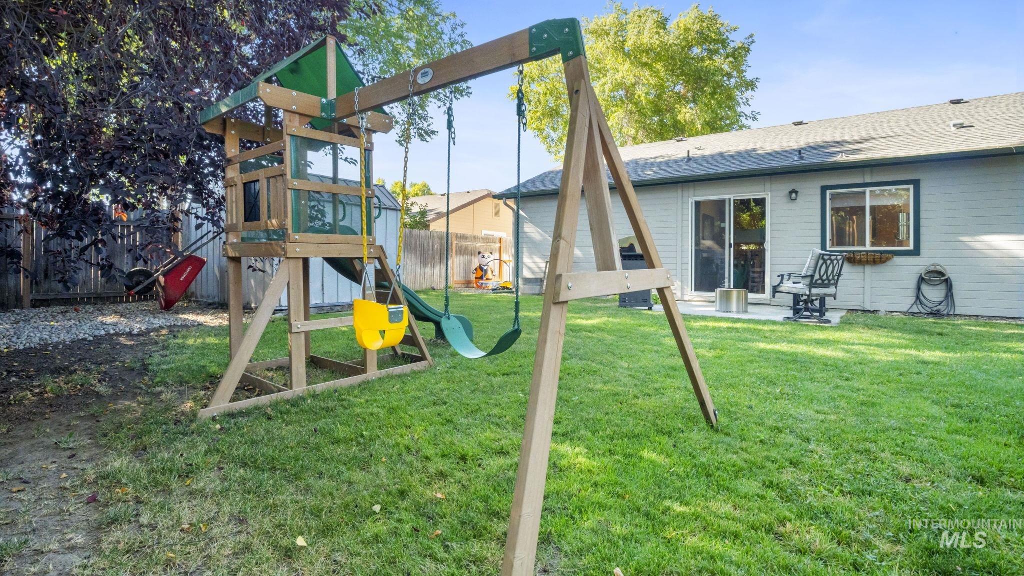 View of playground featuring a patio