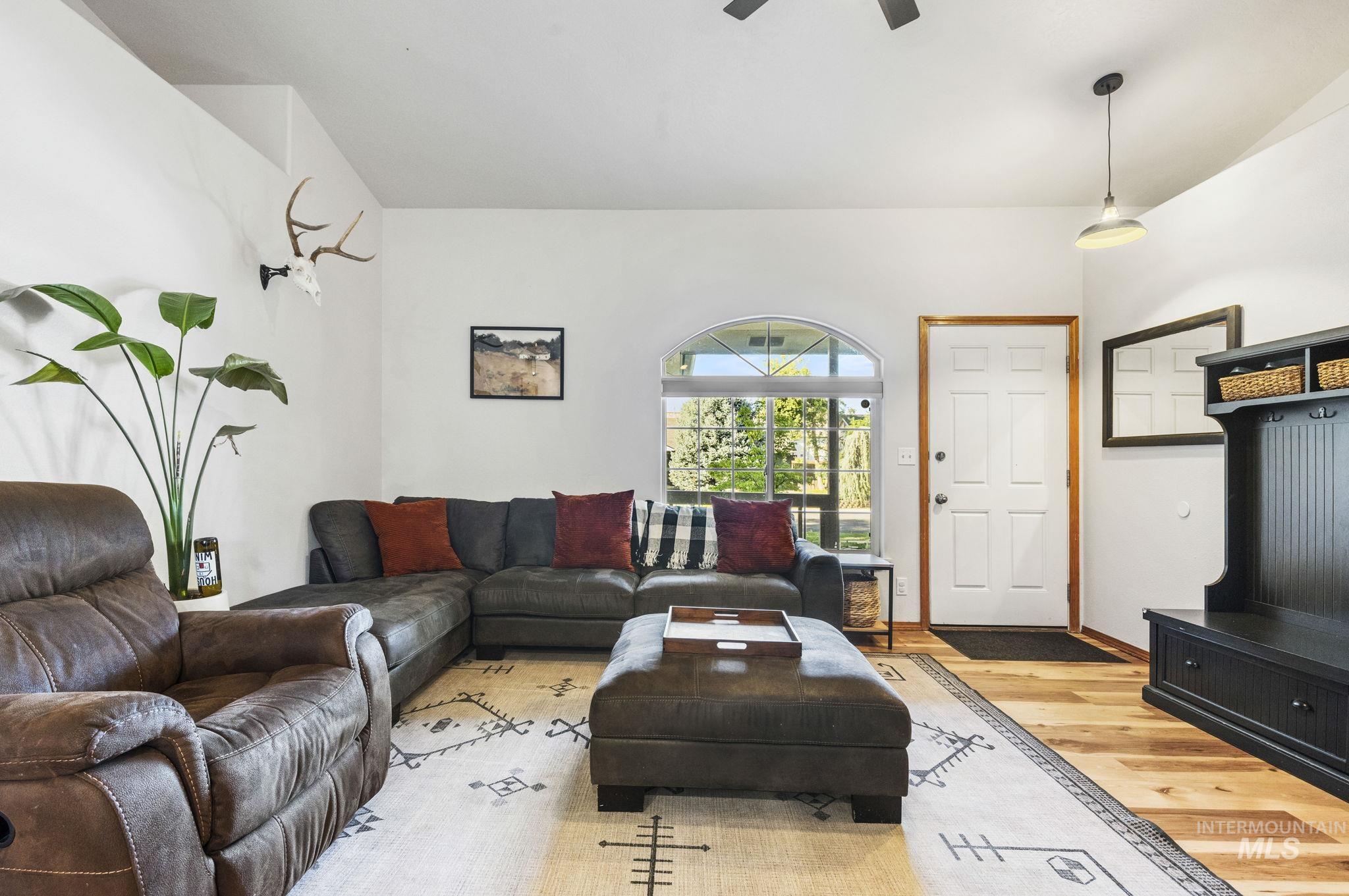 Living area featuring wood finished floors and ceiling fan