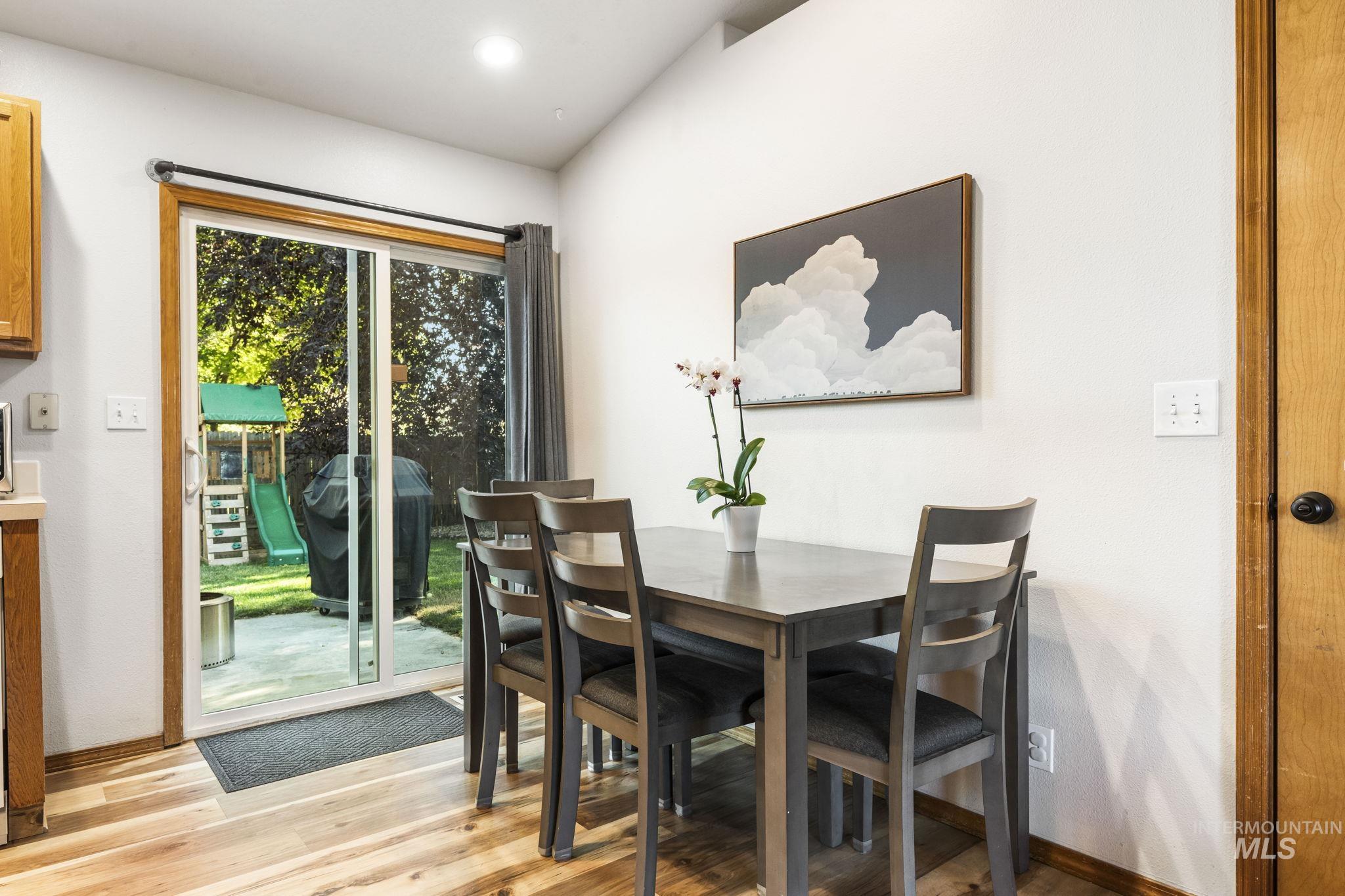 Dining room with light wood-type flooring and recessed lighting