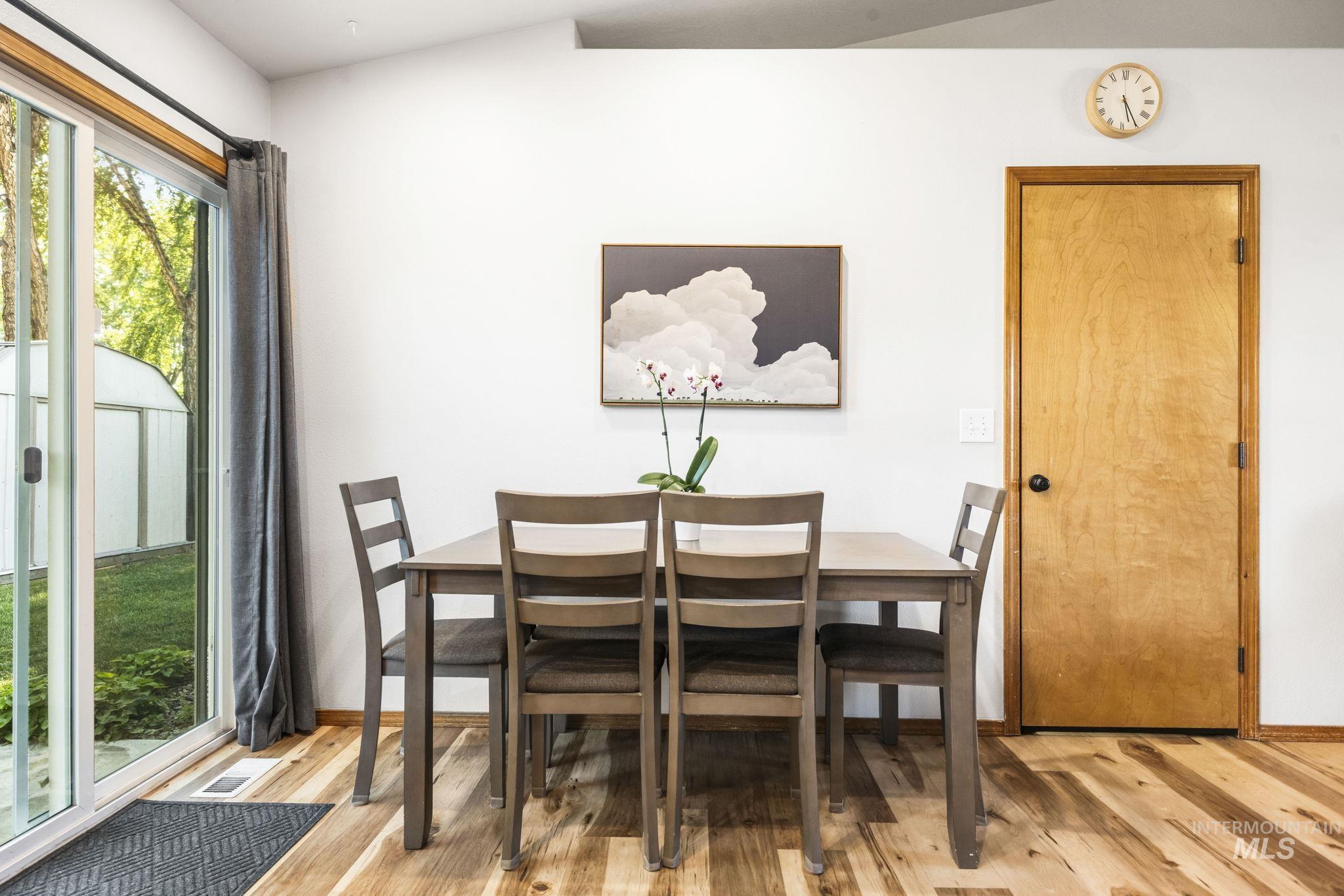 Dining space featuring light wood-style floors and baseboards