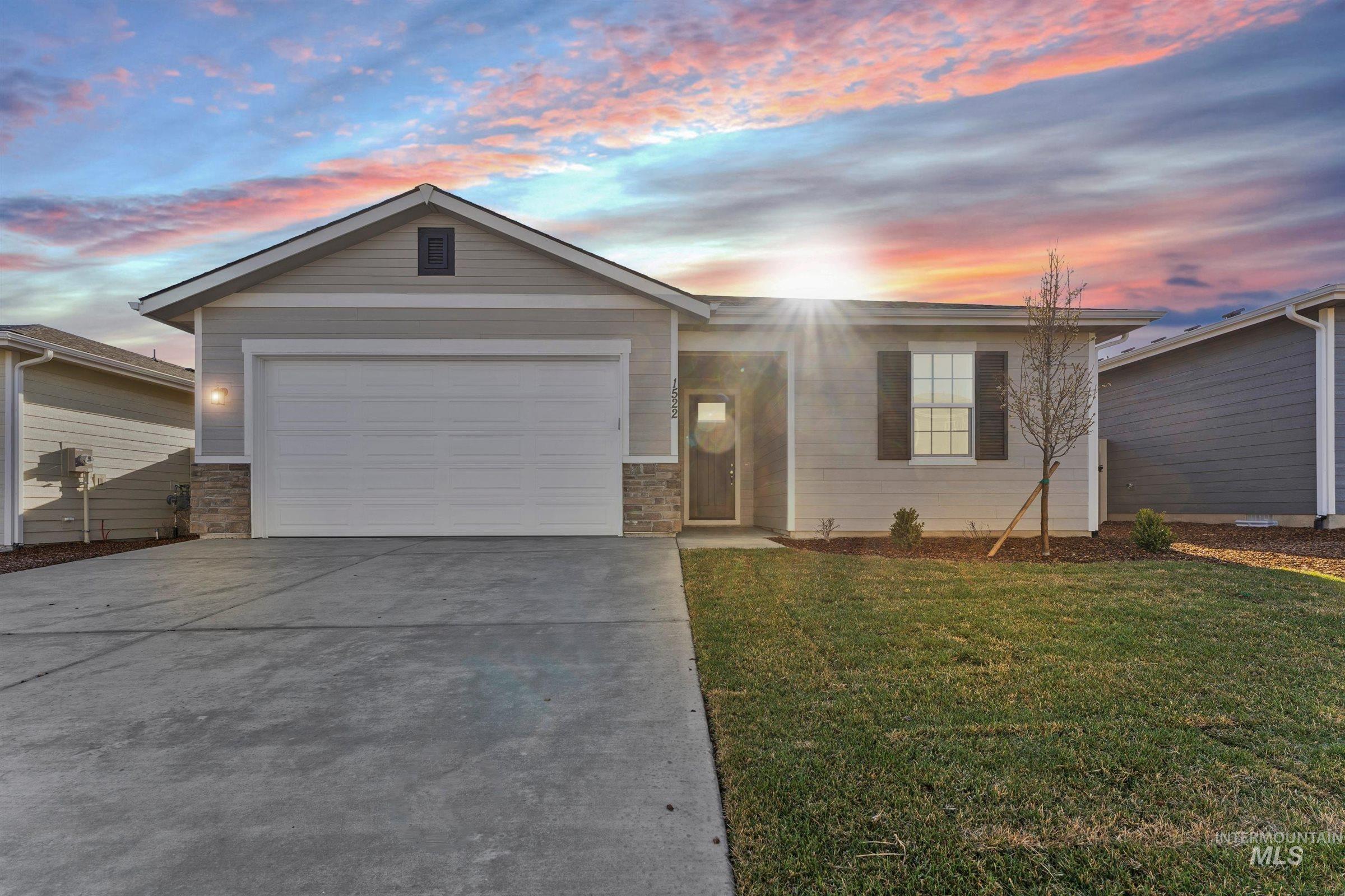 Ranch-style house featuring driveway, a front lawn, and a garage