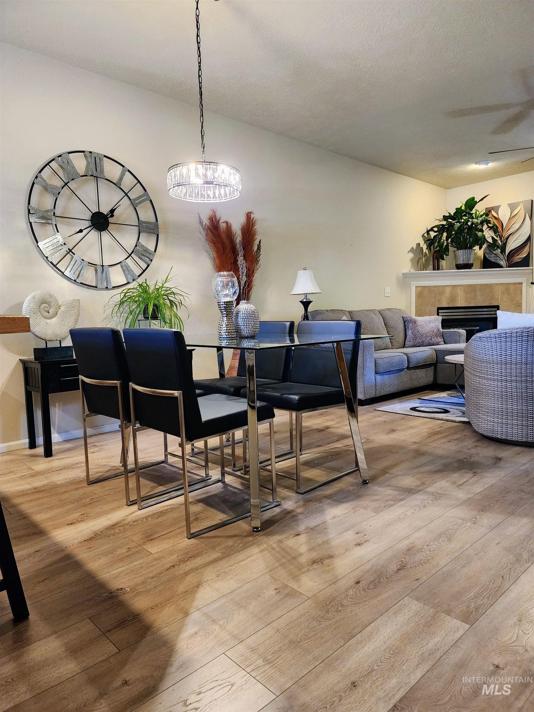 Dining room featuring a tile fireplace and light wood-style flooring