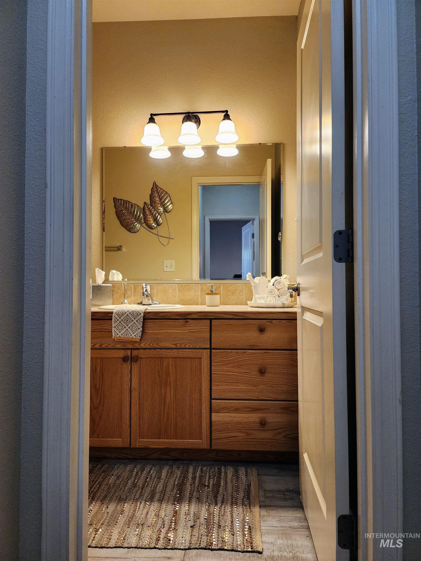 Bathroom featuring vanity and light wood-style floors