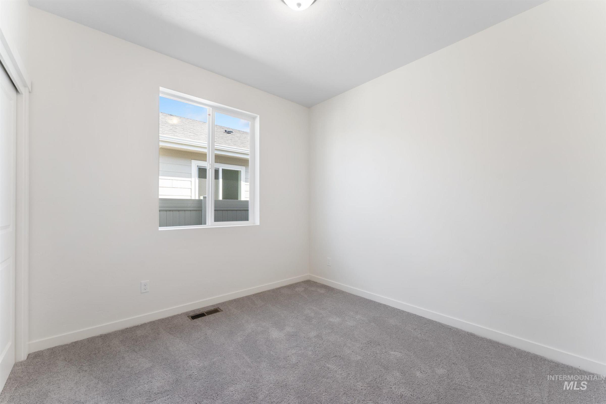 Unfurnished room with carpet and baseboards