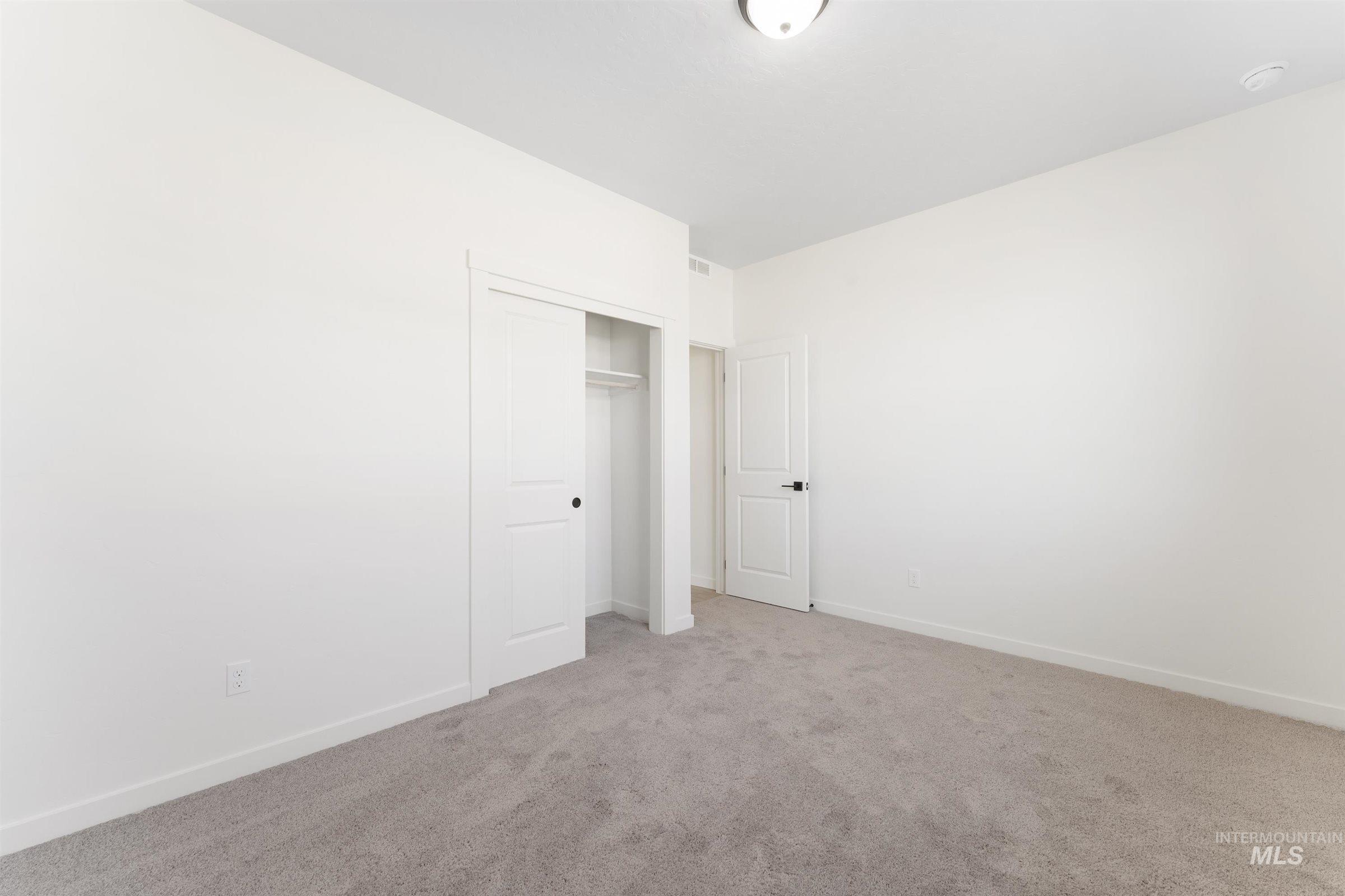 Unfurnished bedroom featuring carpet flooring and a closet
