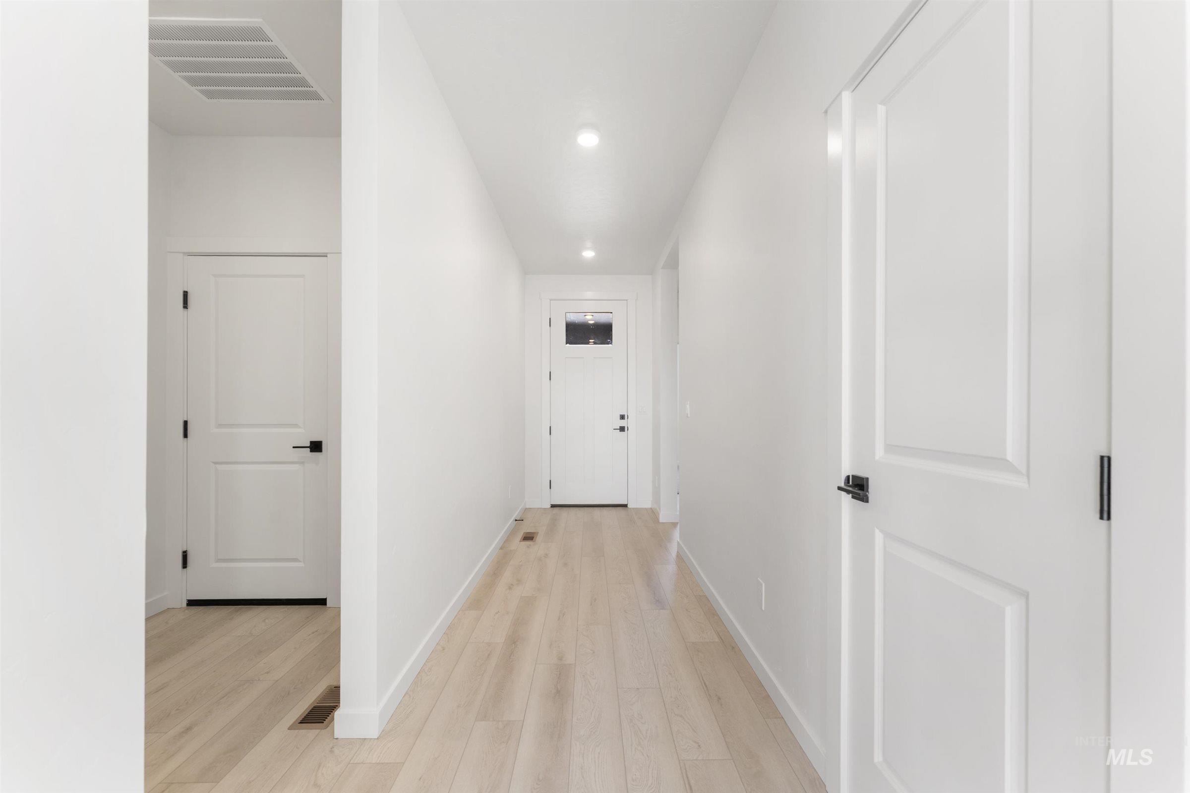 Hall featuring light wood-type flooring and recessed lighting