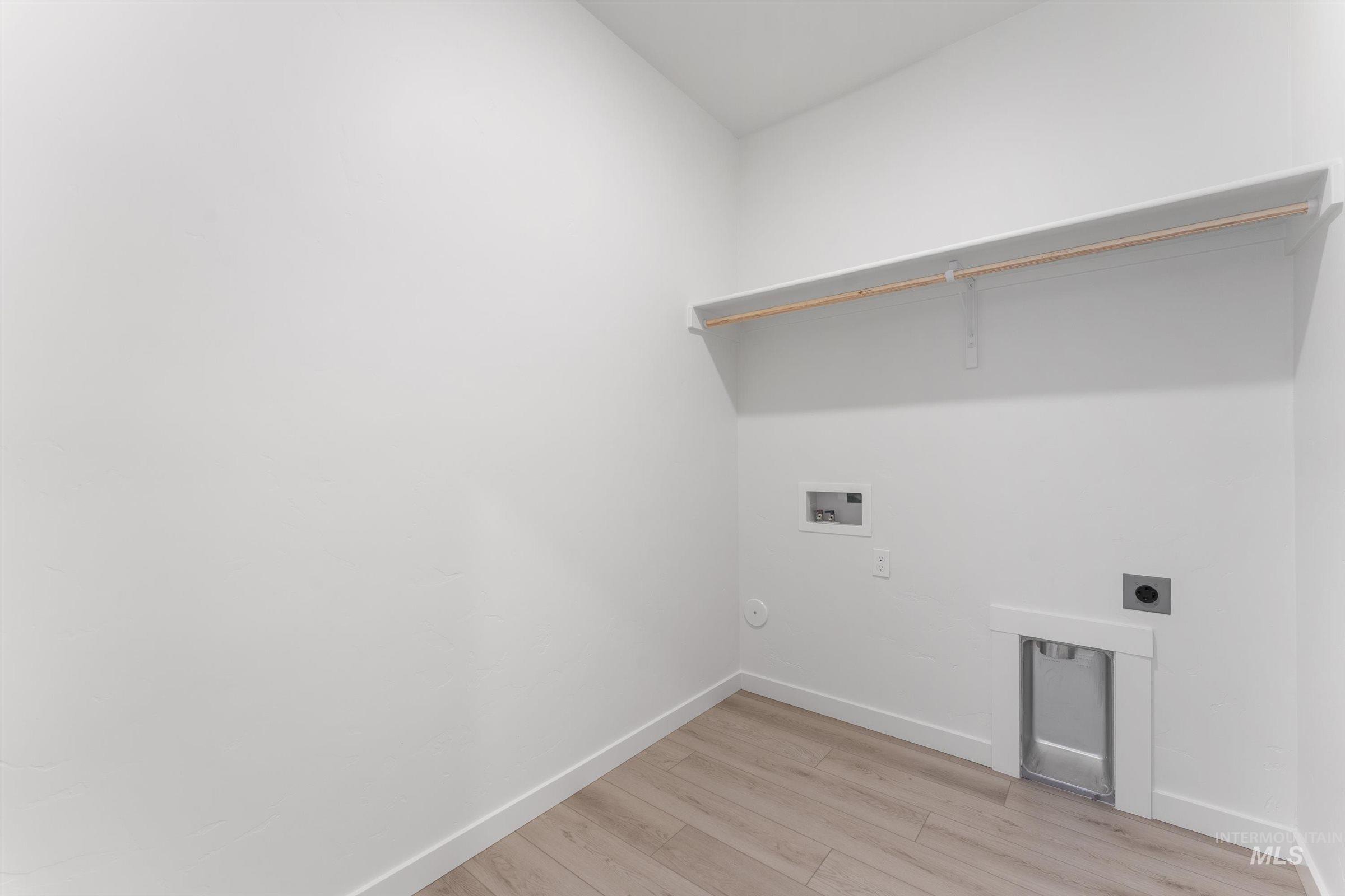 Laundry room featuring light wood-style flooring, electric dryer hookup, and hookup for a washing machine