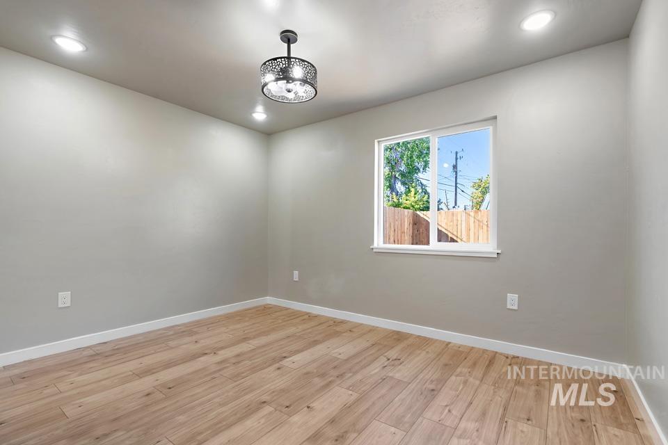 Spare room with light wood-type flooring and recessed lighting