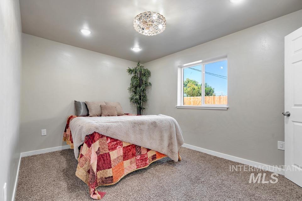 Carpeted bedroom with baseboards