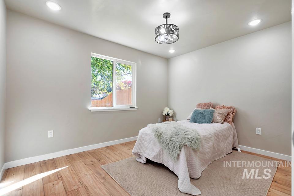 Bedroom with light wood-style floors and recessed lighting