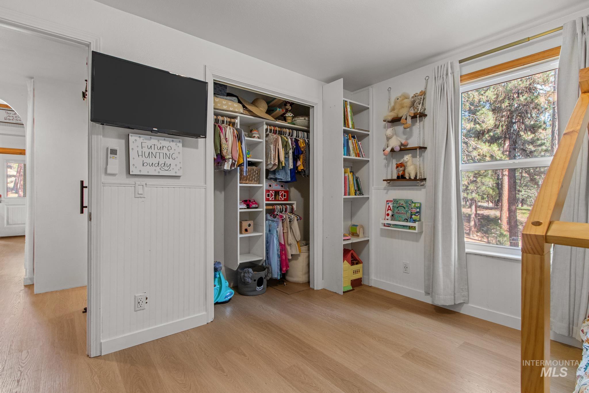Bedroom featuring light wood finished floors and a closet