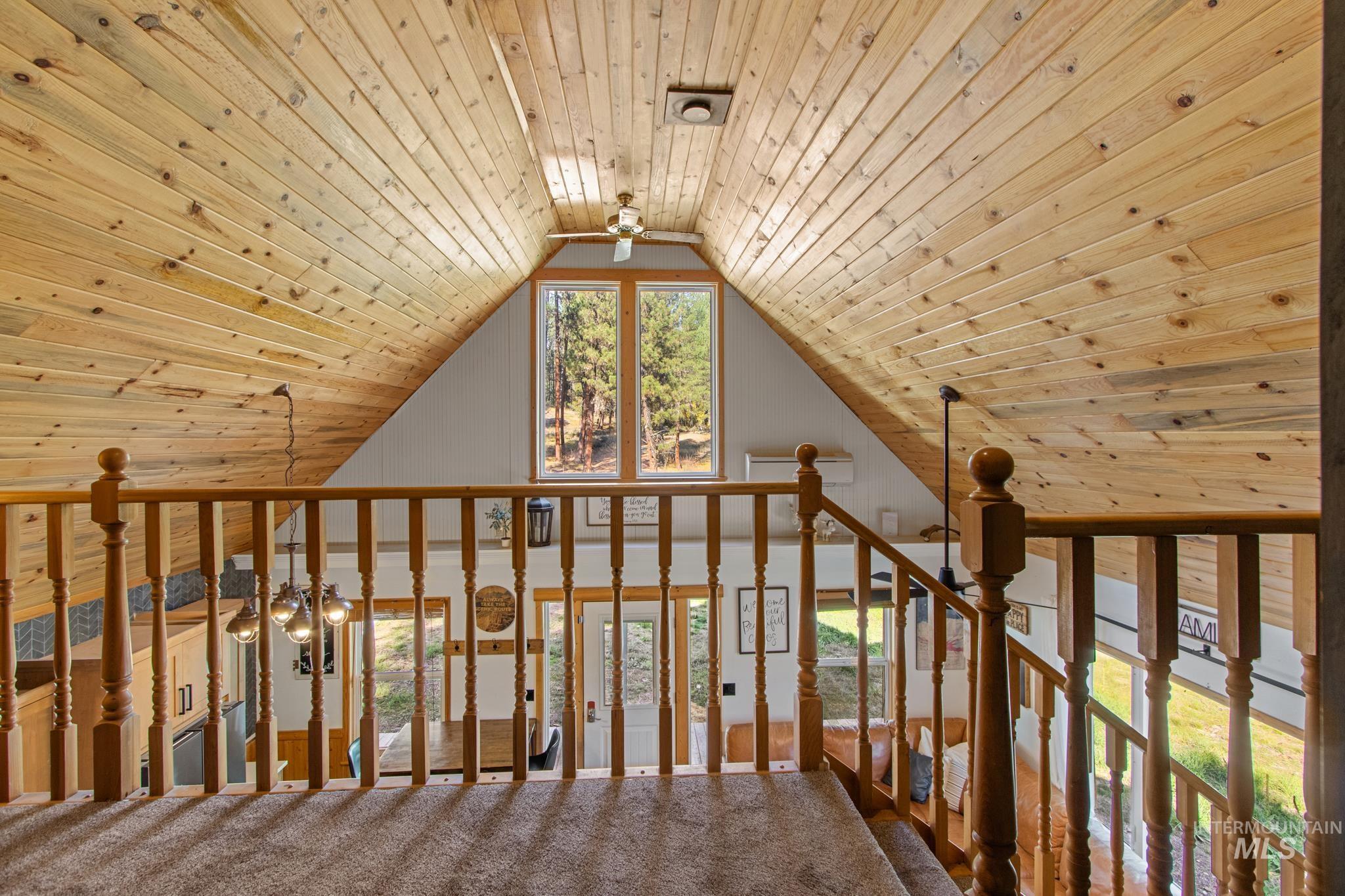 Bonus room featuring wood ceiling, ceiling fan, carpet floors, and vaulted ceiling