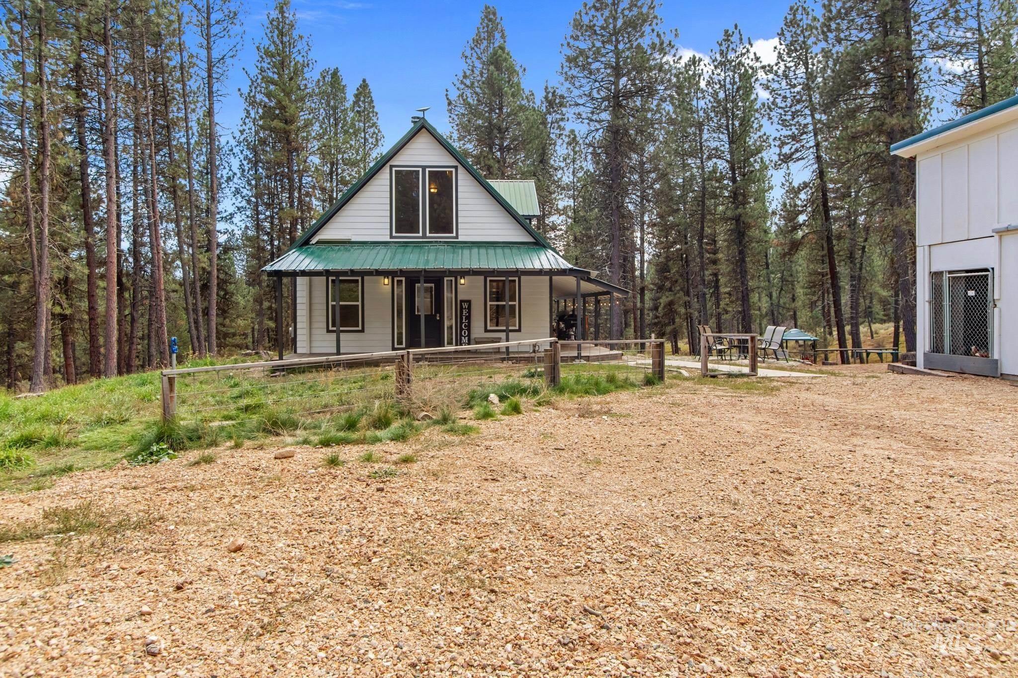 Rear view of property featuring covered porch and a metal roof