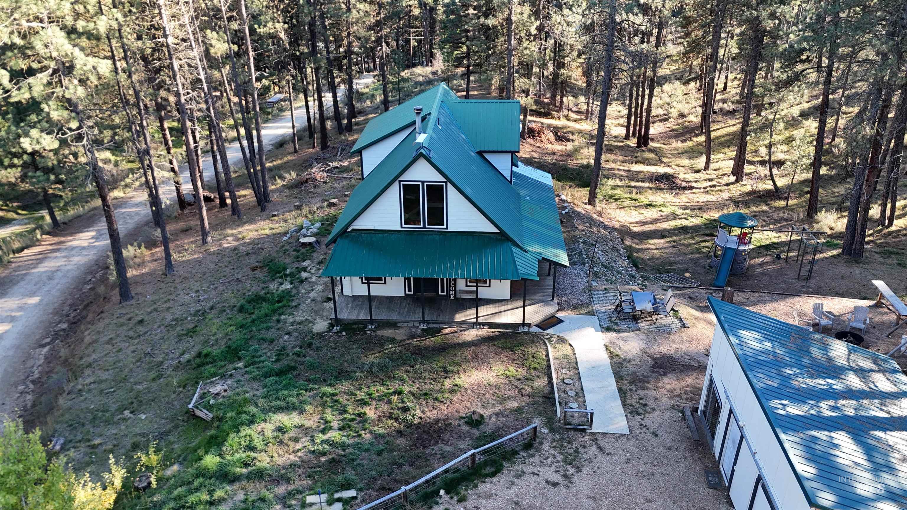 View of front of house featuring a metal roof and a porch