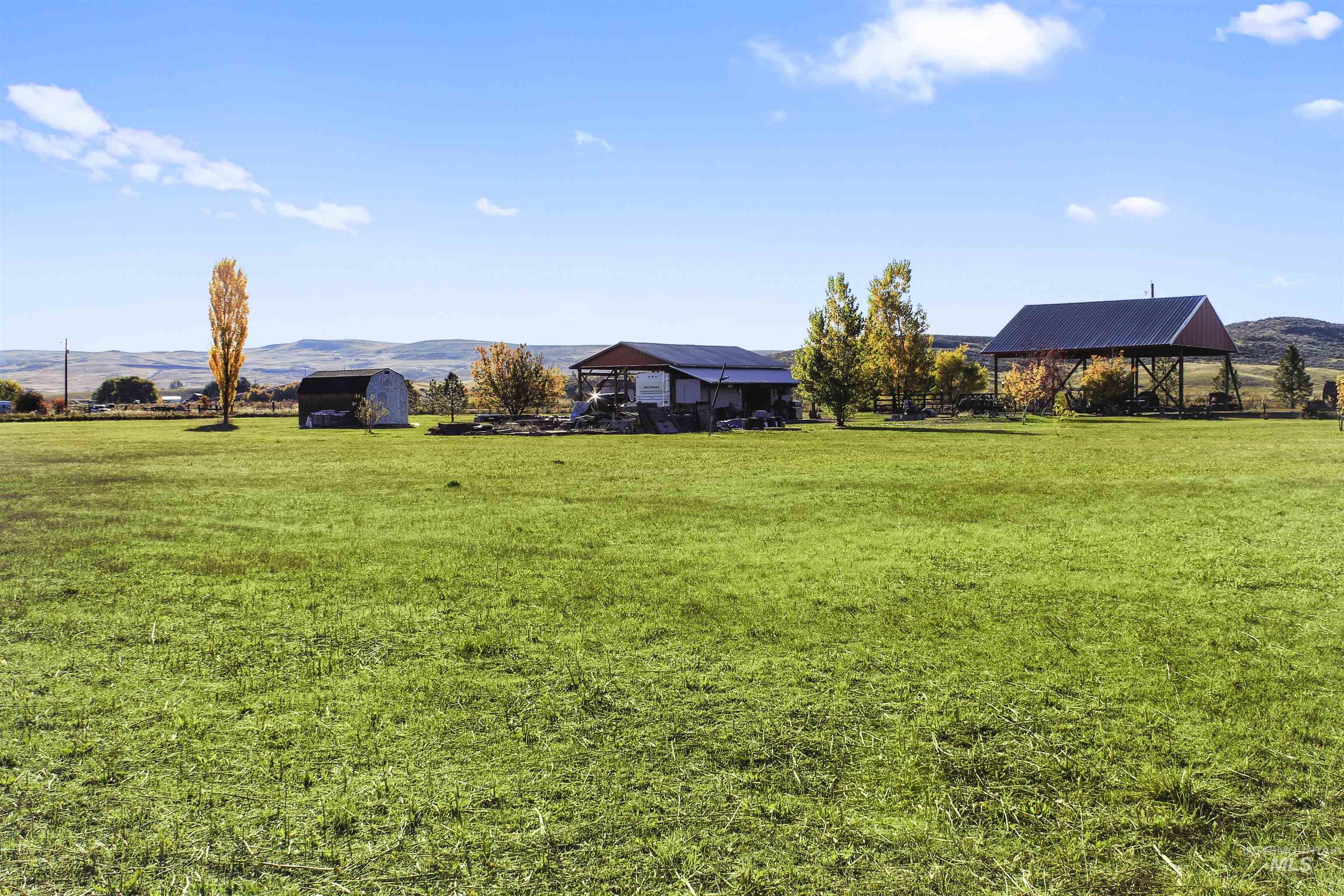 View of green lawn featuring a mountain view and a rural view