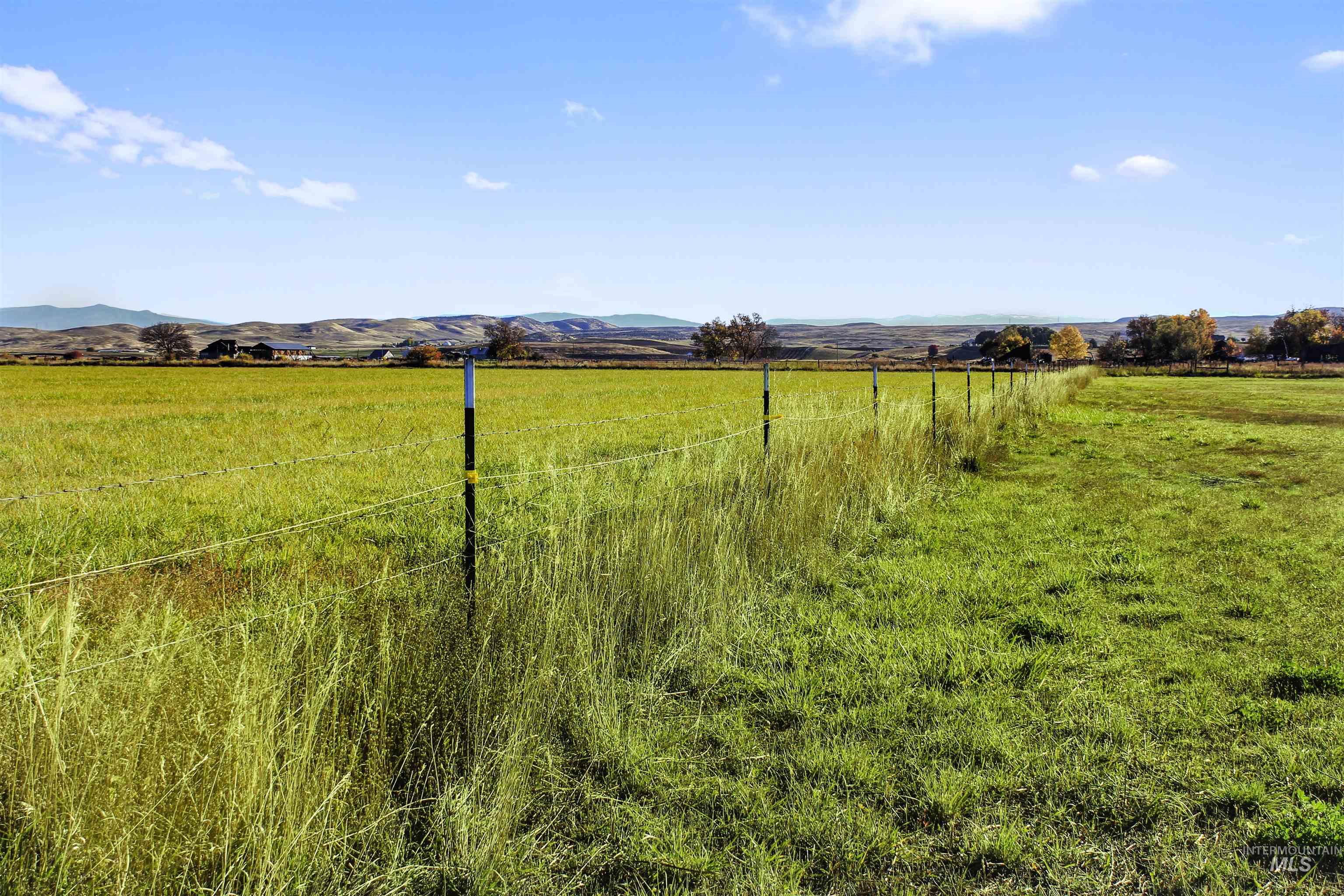 View of yard with a rural view and a mountain view