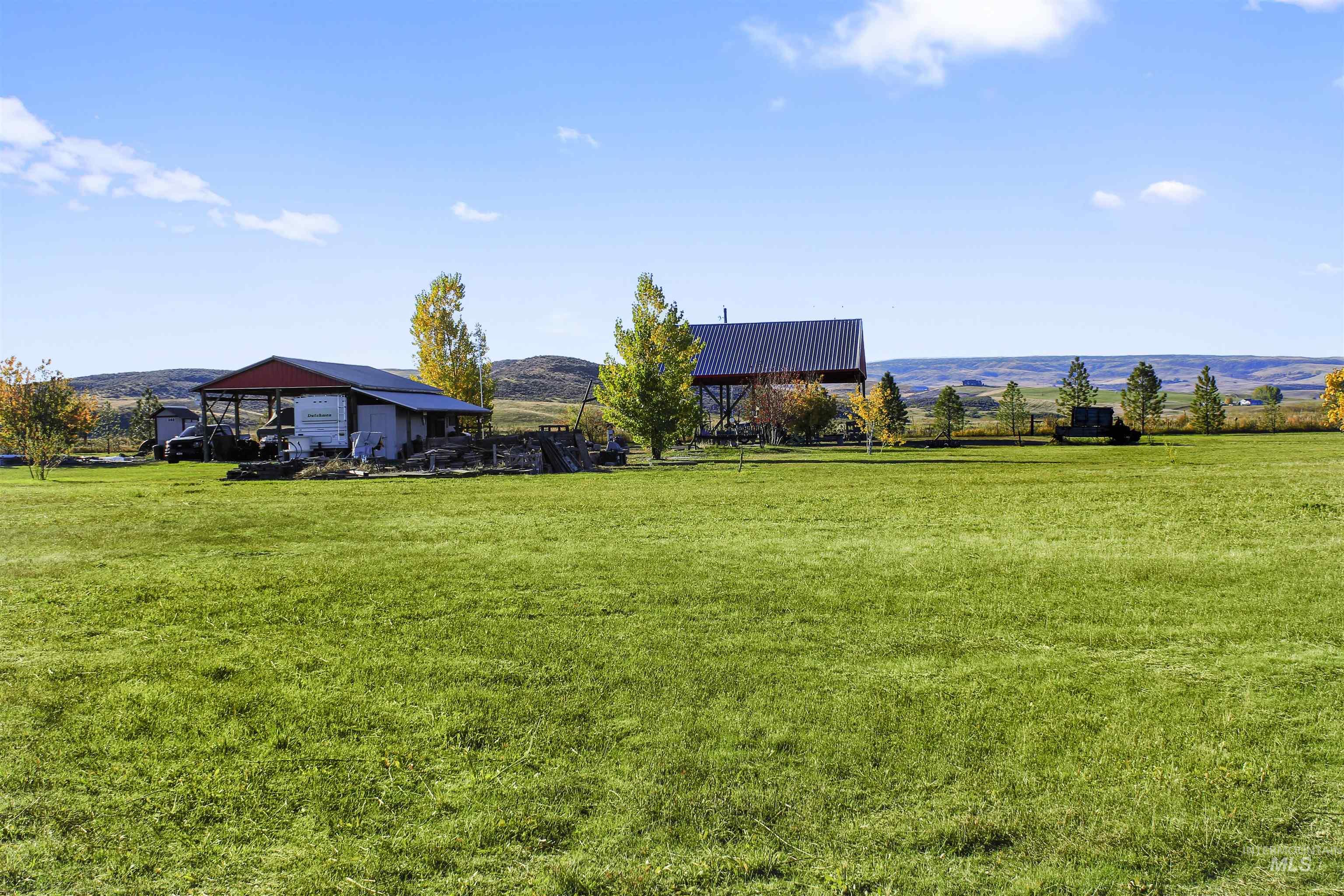 View of green lawn with a mountain view and a view of countryside