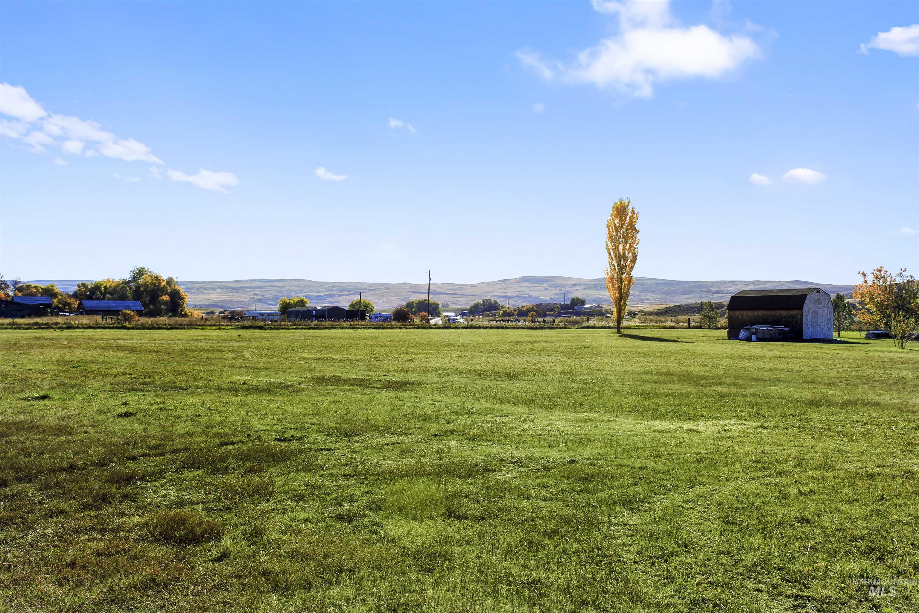 View of grassy yard with a view of countryside and a mountain view