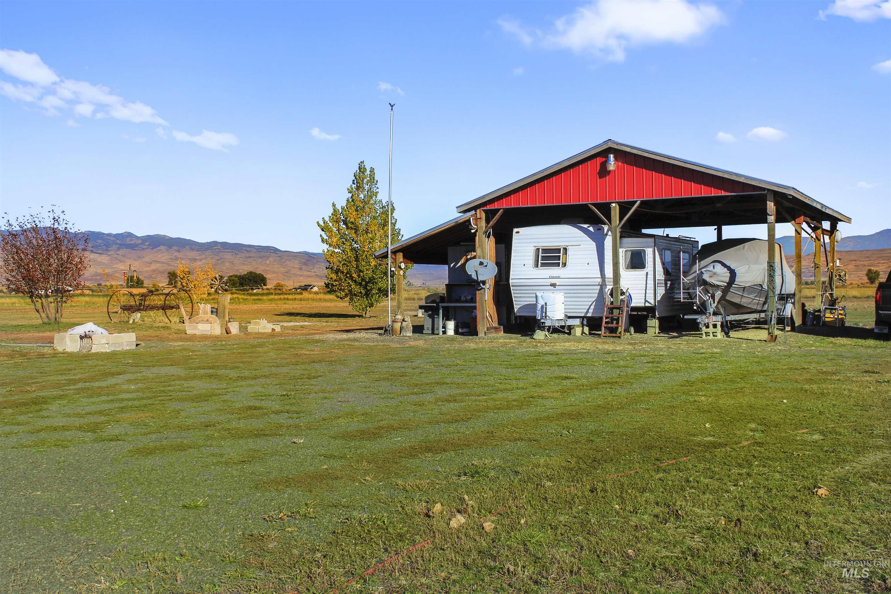 View of grassy yard featuring a mountain view and a rural view