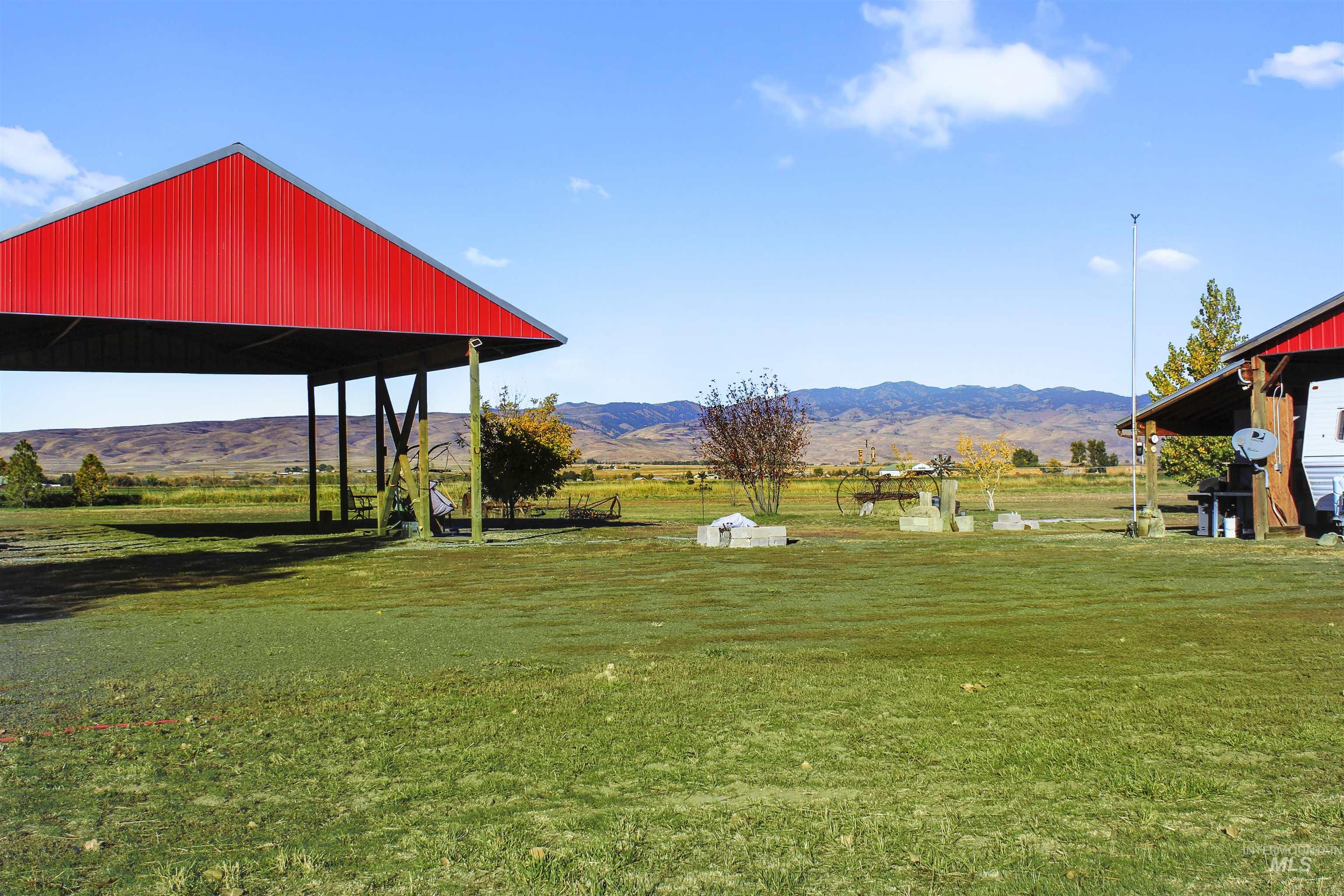 View of green lawn featuring a rural view and a mountain view