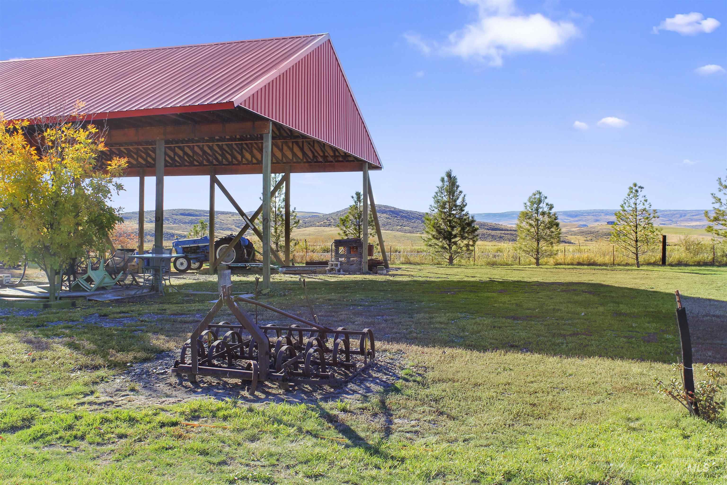 View of grassy yard featuring a rural view and a patio area