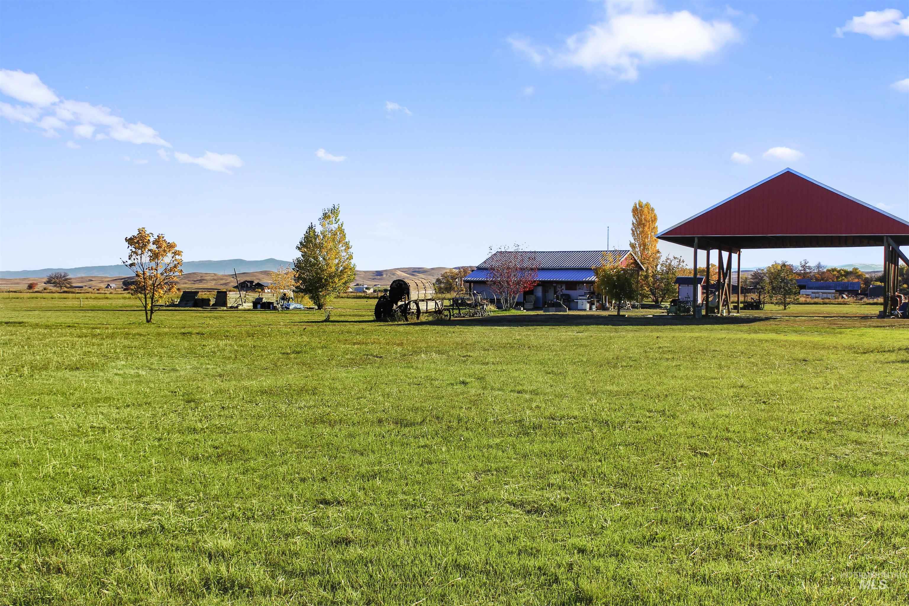 View of grassy yard featuring a mountain view and a rural view