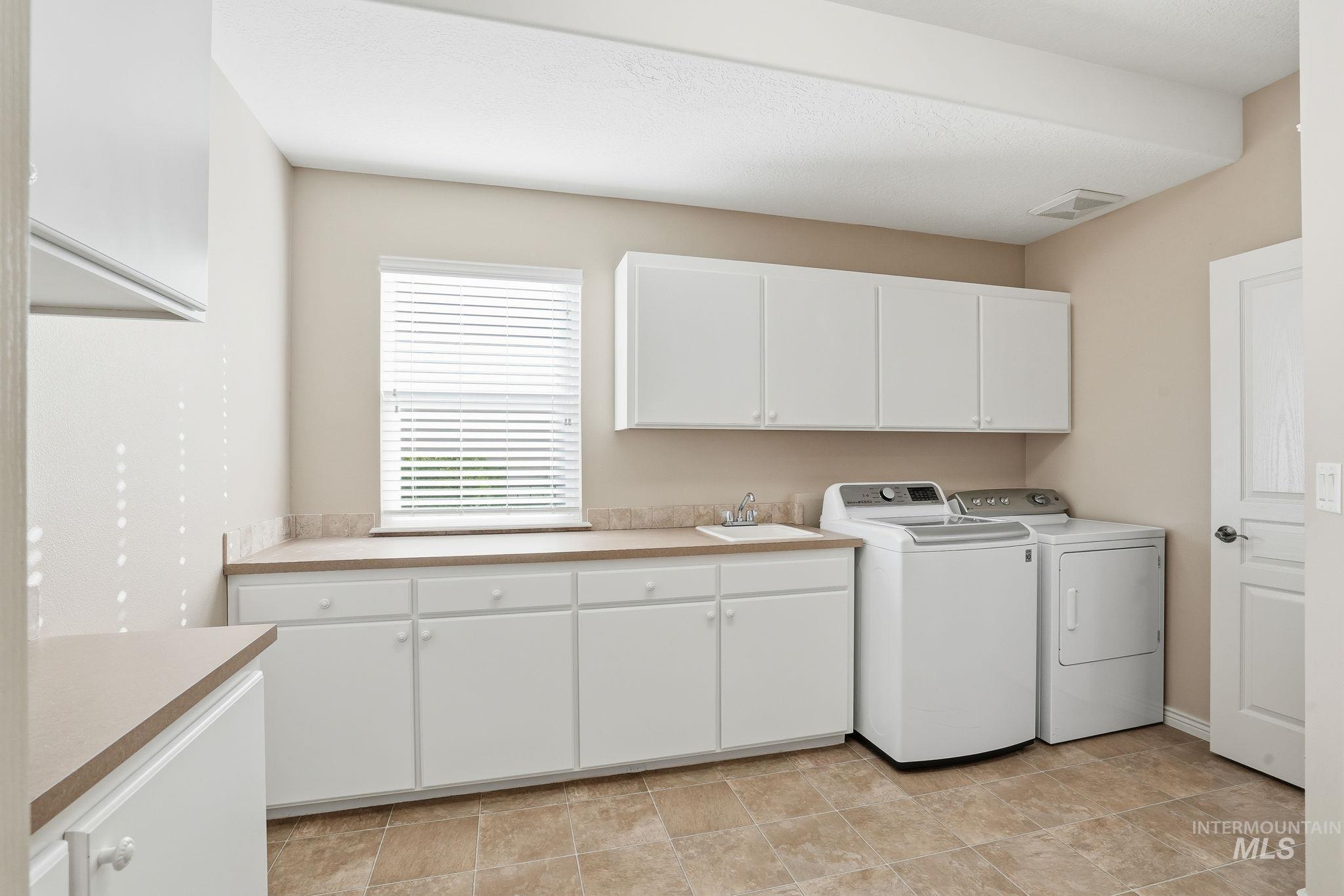 Laundry room featuring cabinet space and washing machine and dryer