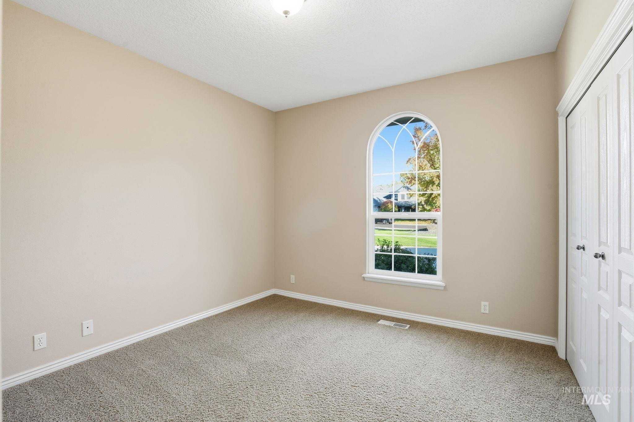 Unfurnished bedroom with a closet and light carpet