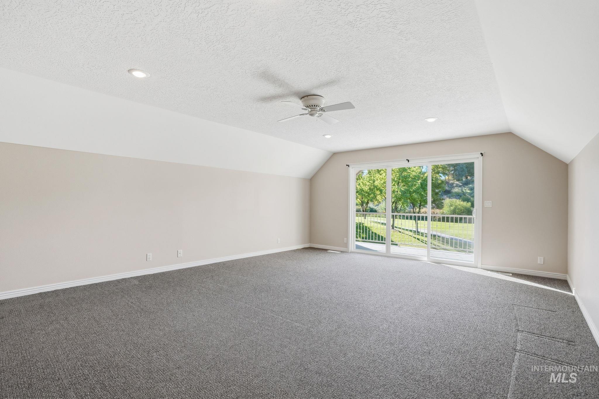 Bonus room featuring lofted ceiling, carpet flooring, a ceiling fan, a textured ceiling, and recessed lighting
