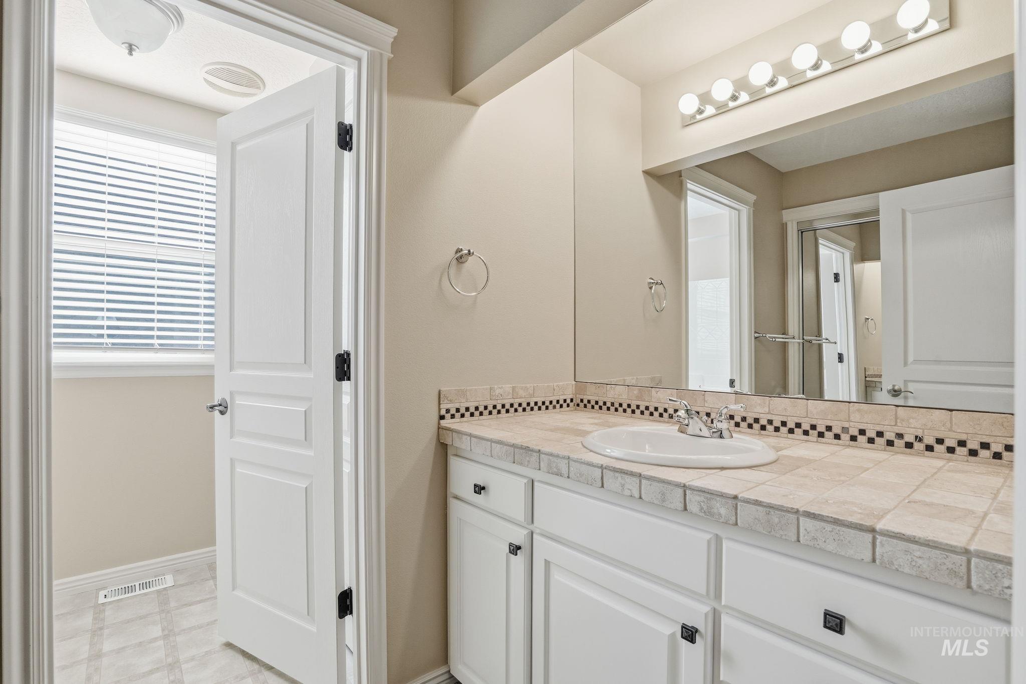Bathroom featuring vanity and baseboards