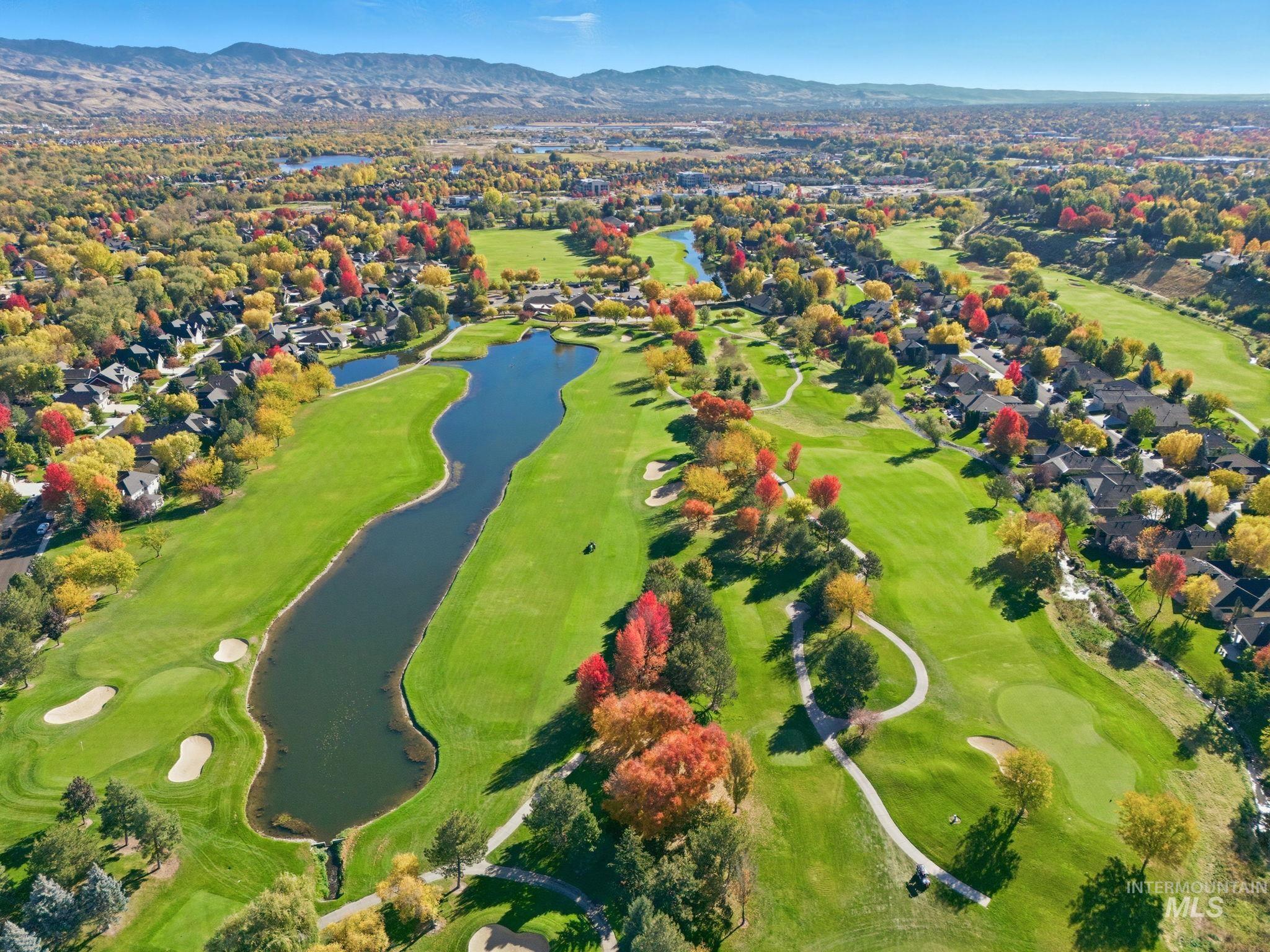 Drone / aerial view of a water and mountain view and a golf course