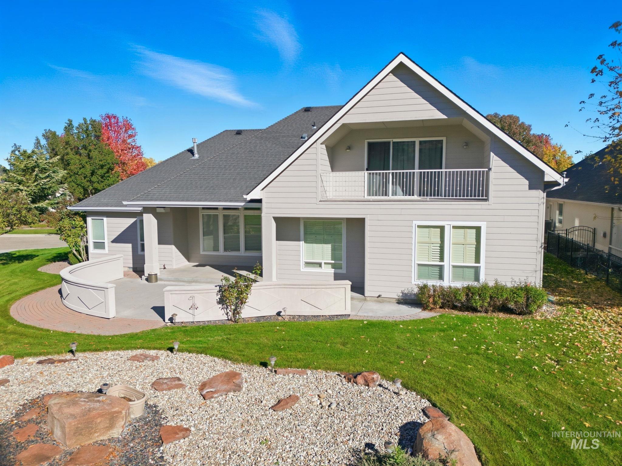 Rear view of property featuring a patio and a balcony