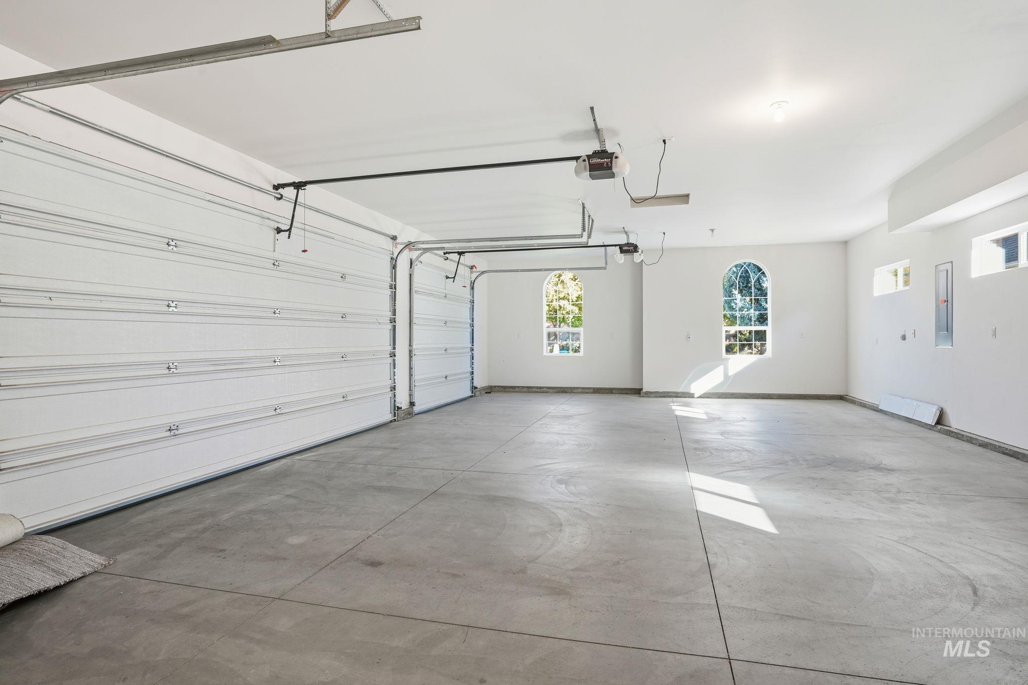 Garage with electric panel and a garage door opener