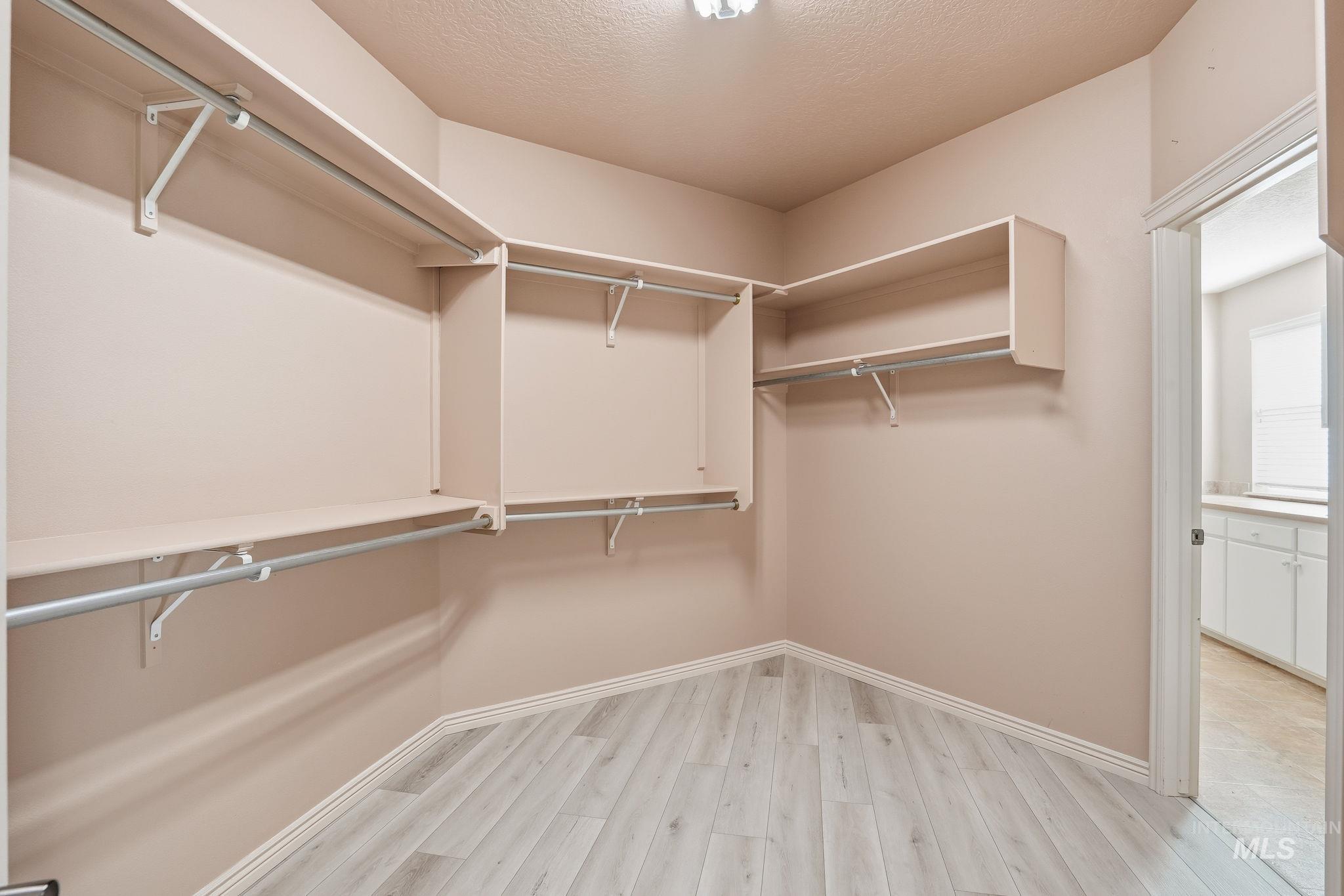 Walk in closet featuring light wood-style flooring