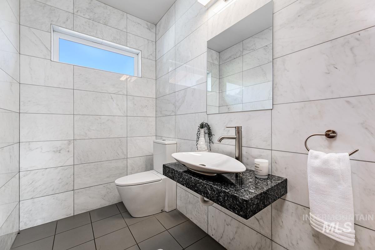 Bathroom with tile walls and tile patterned floors