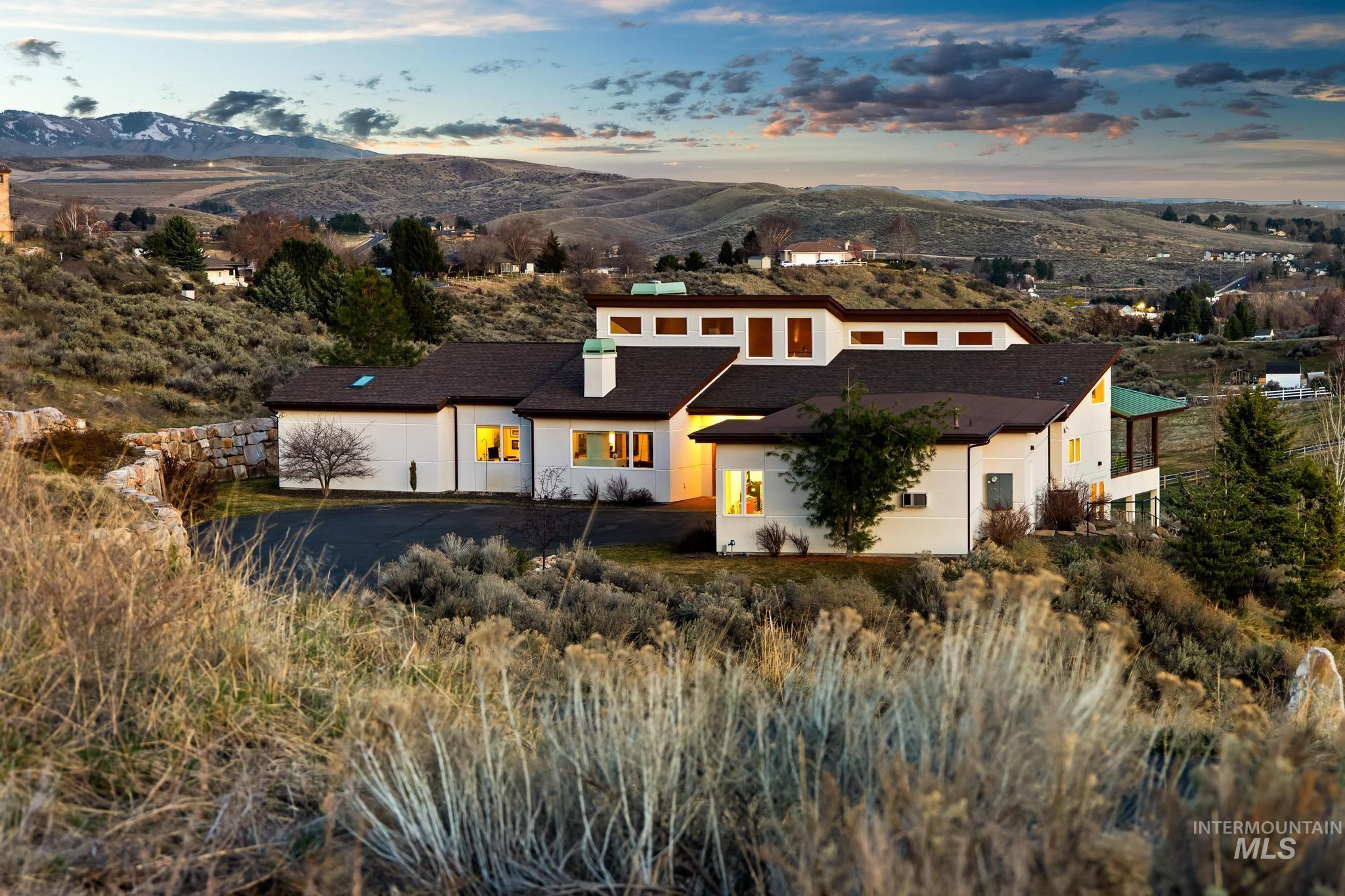 View of front facade with stucco siding, a mountain view, and a chimney