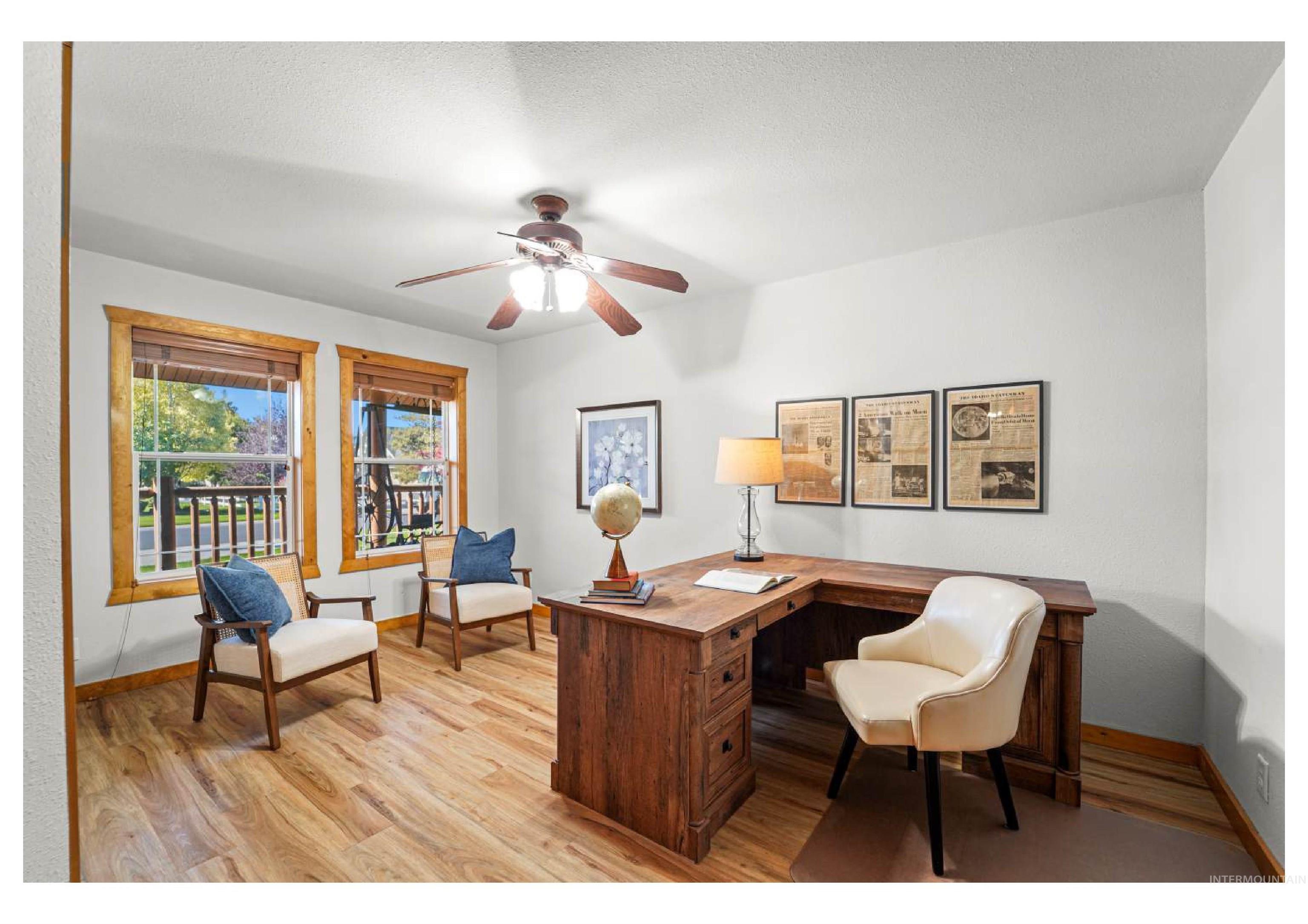 Office area featuring light wood-style flooring and ceiling fan