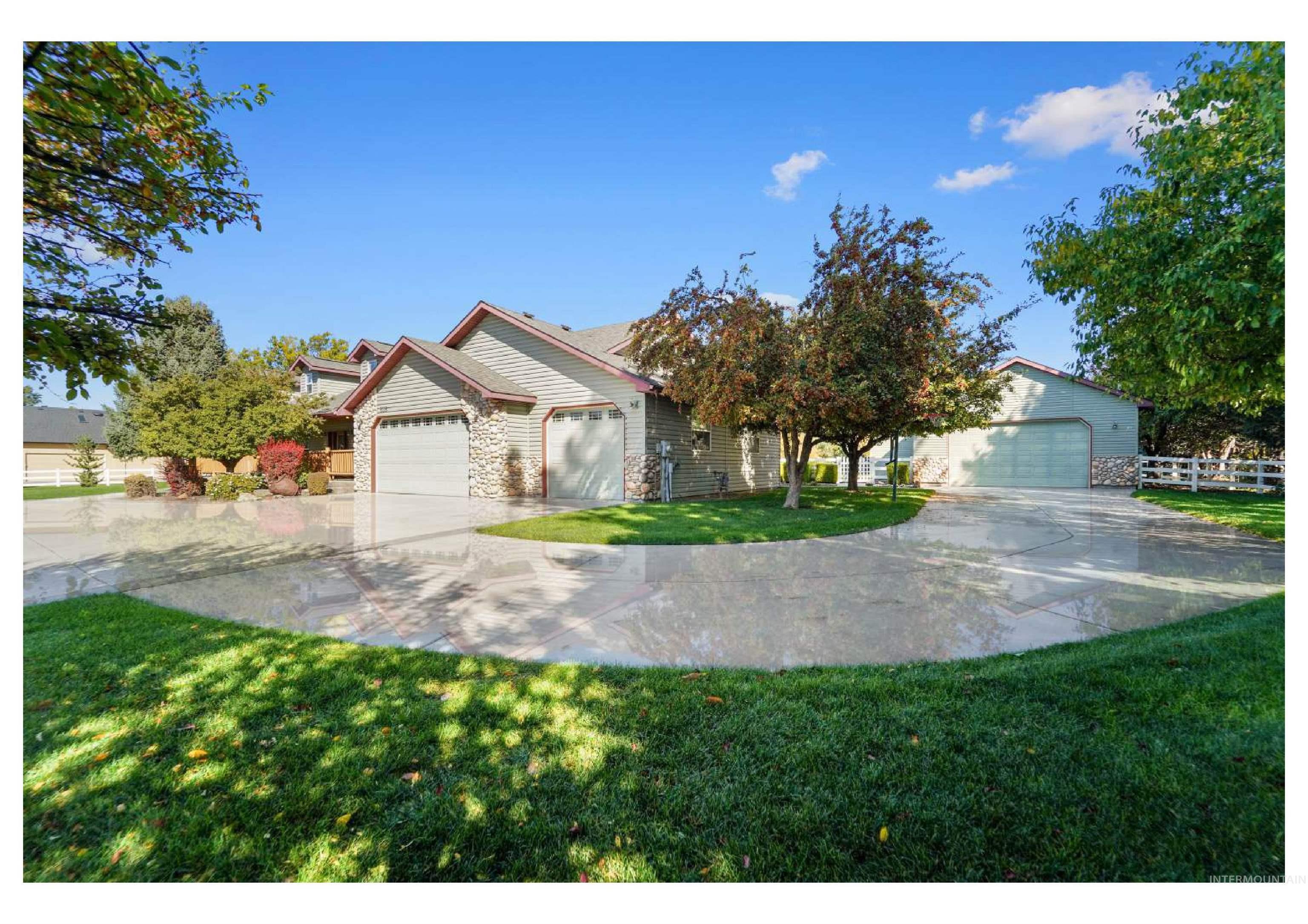 View of front of property with a front lawn, driveway, and an attached garage