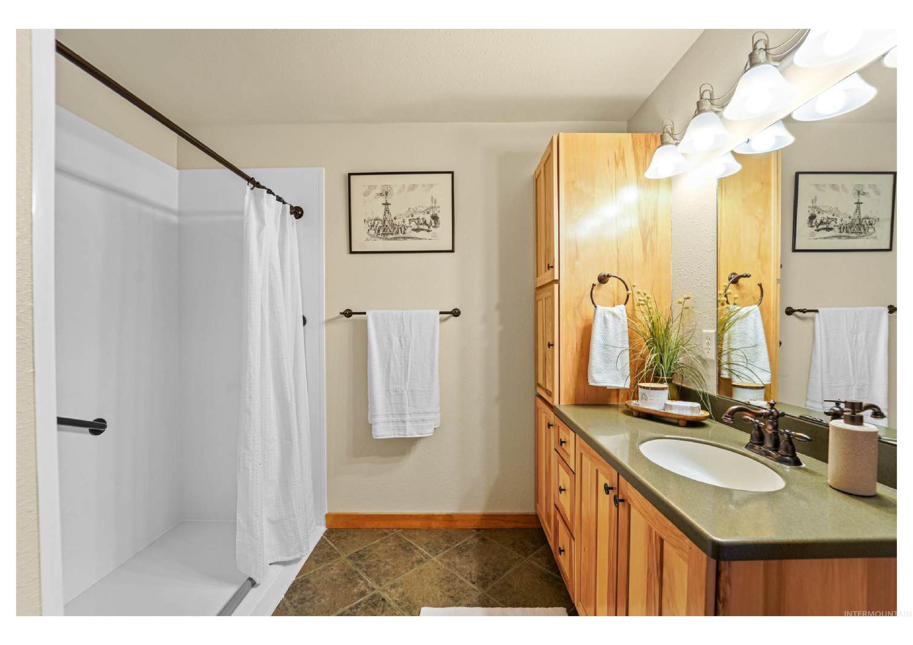 Full bath featuring vanity and a shower stall